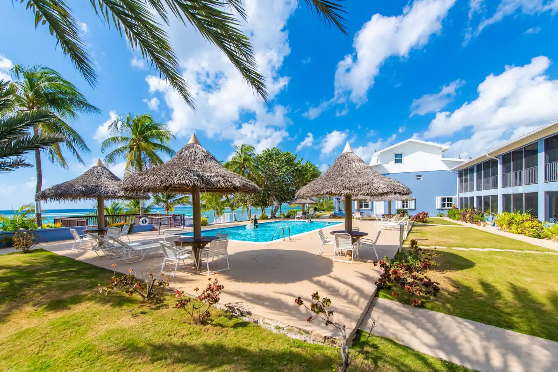 Swimming pool with beautiful ocean views. Sun deck, thatch parasol tables, chairs and loungers provided.