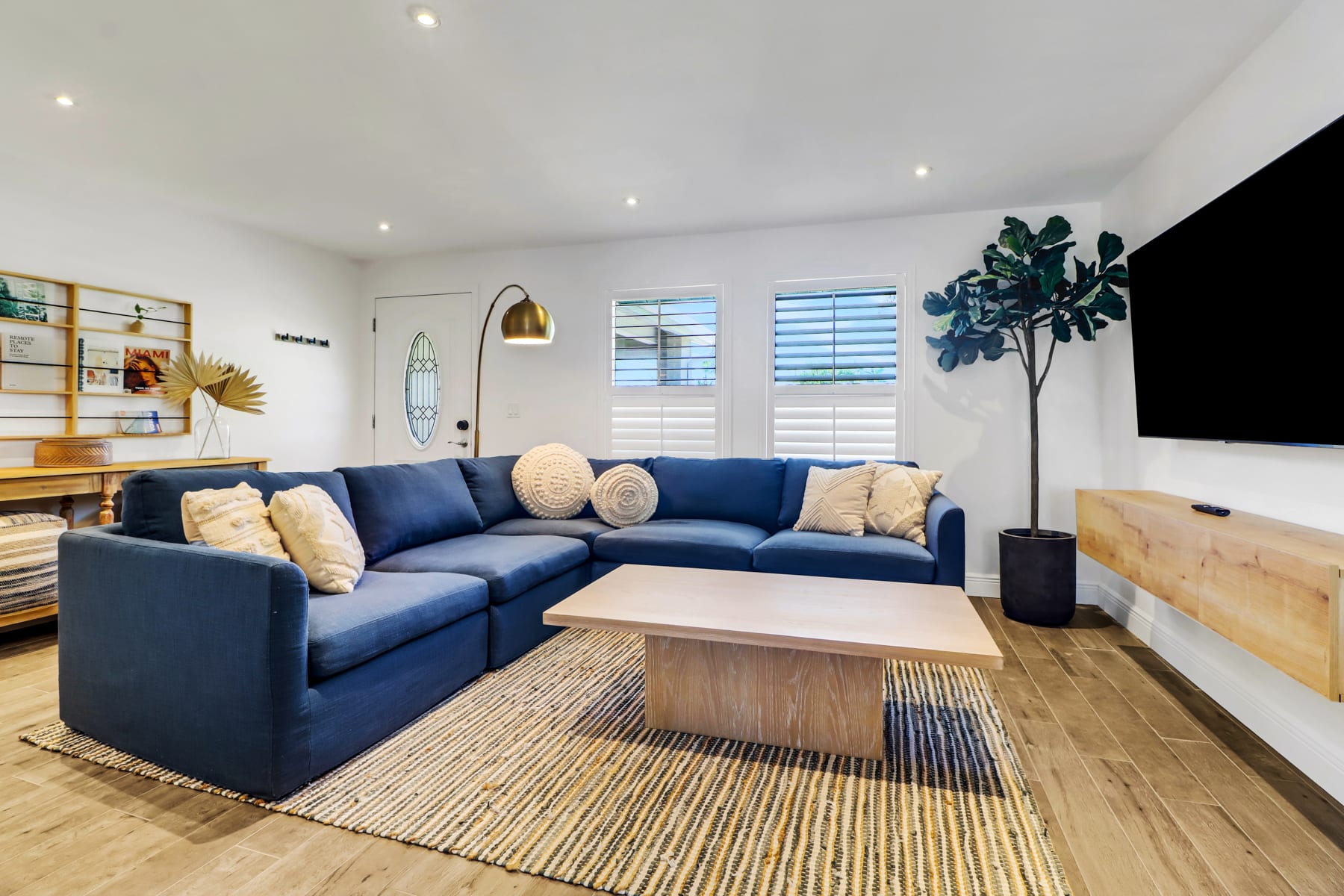 Main indoor Living room features a huge plush sectional, large Smart TV