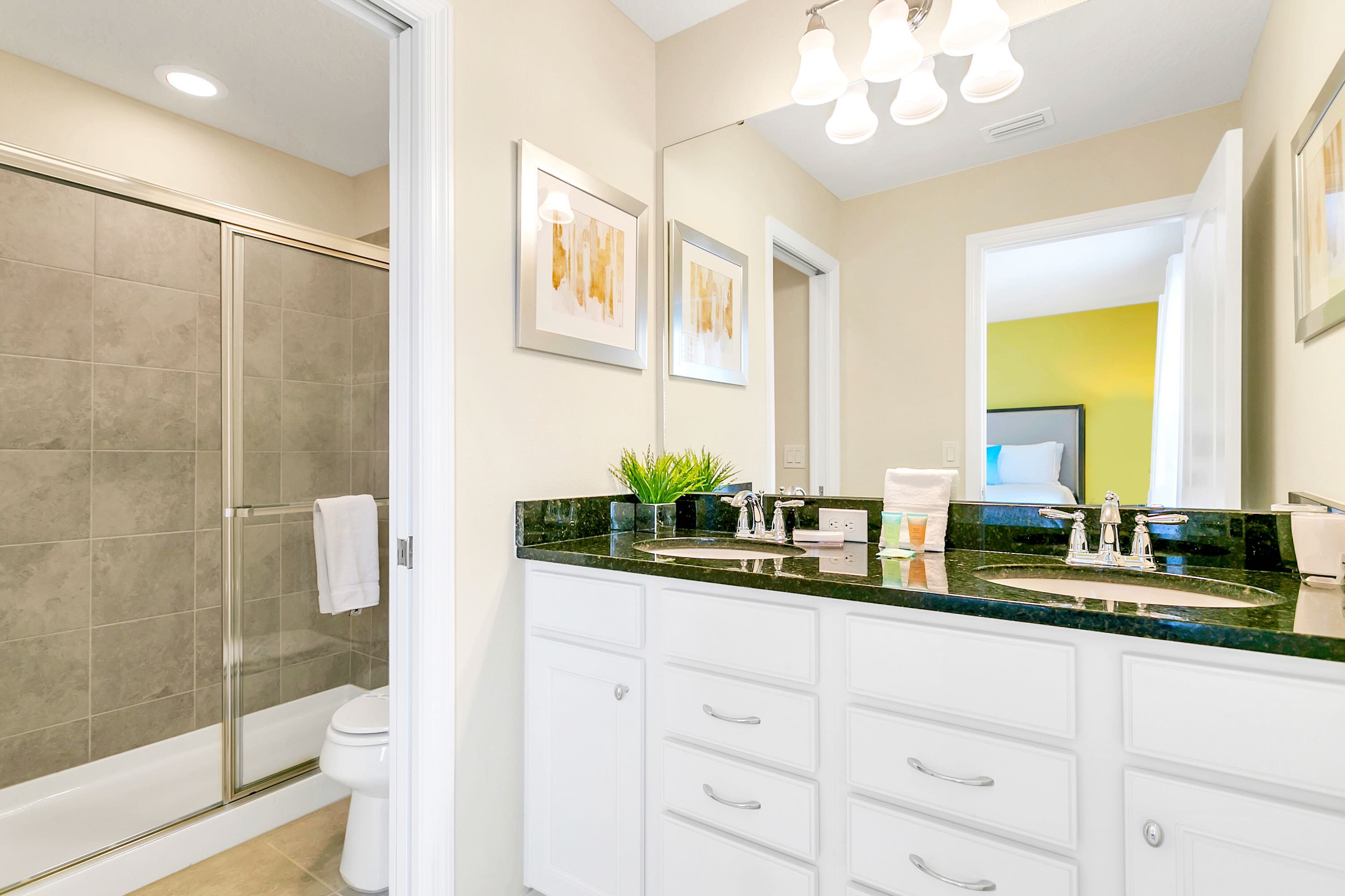 Spacious And Elegant Bathroom With Double Sinks And A Walking Shower