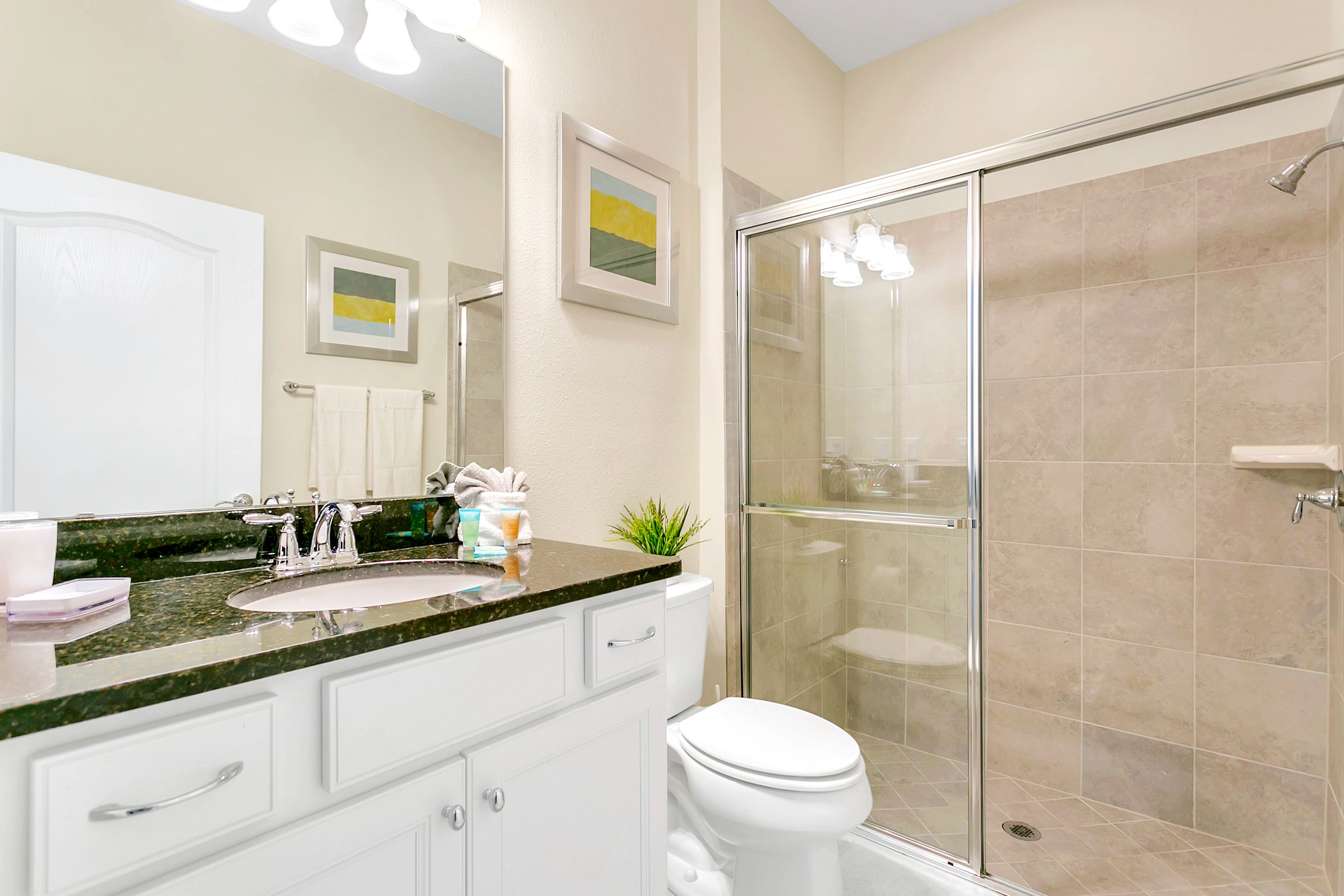 Spacious And Elegant Bathroom With Double Sinks And A Walking Shower