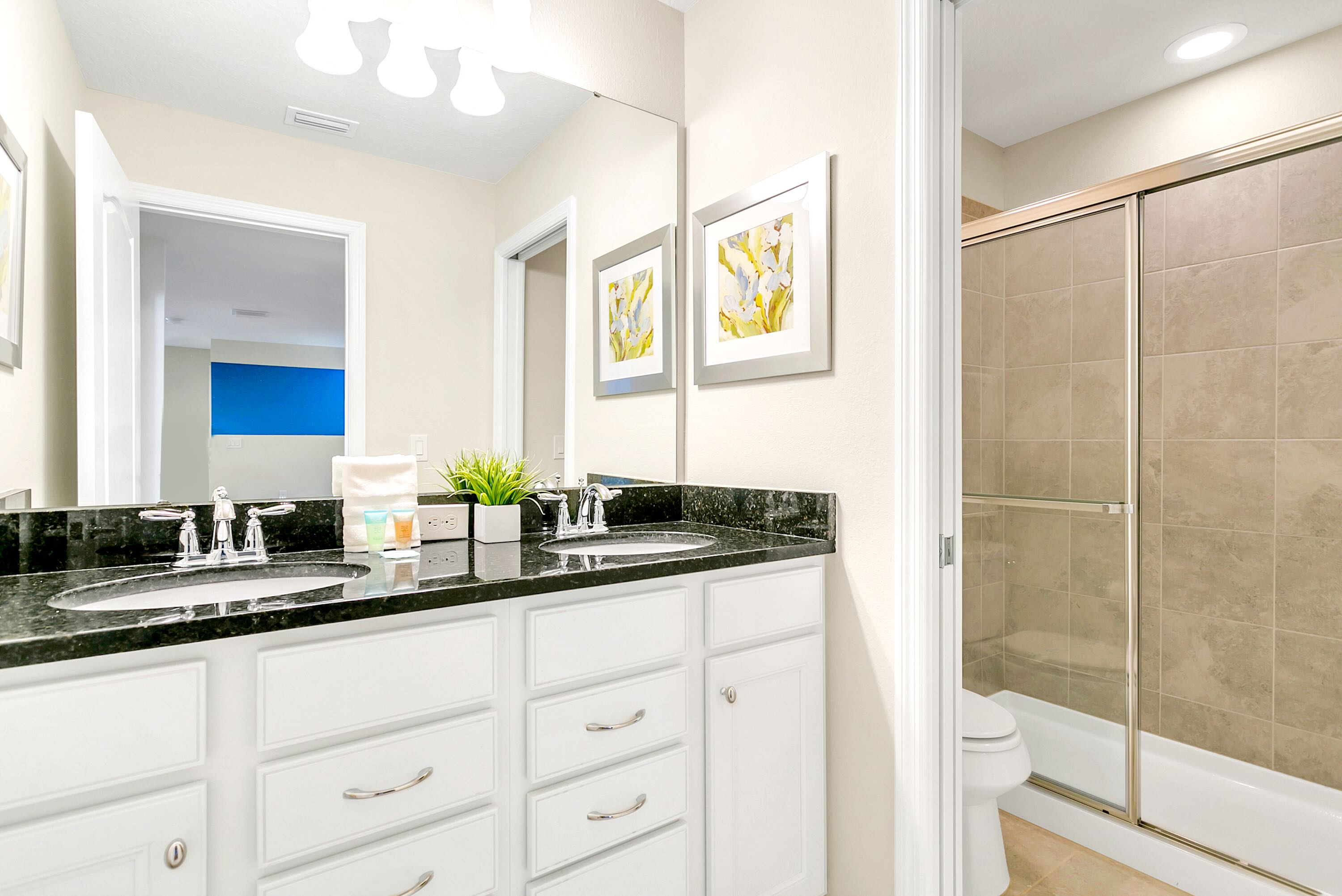 Spacious And Elegant Bathroom With Double Sinks And A Walking Shower