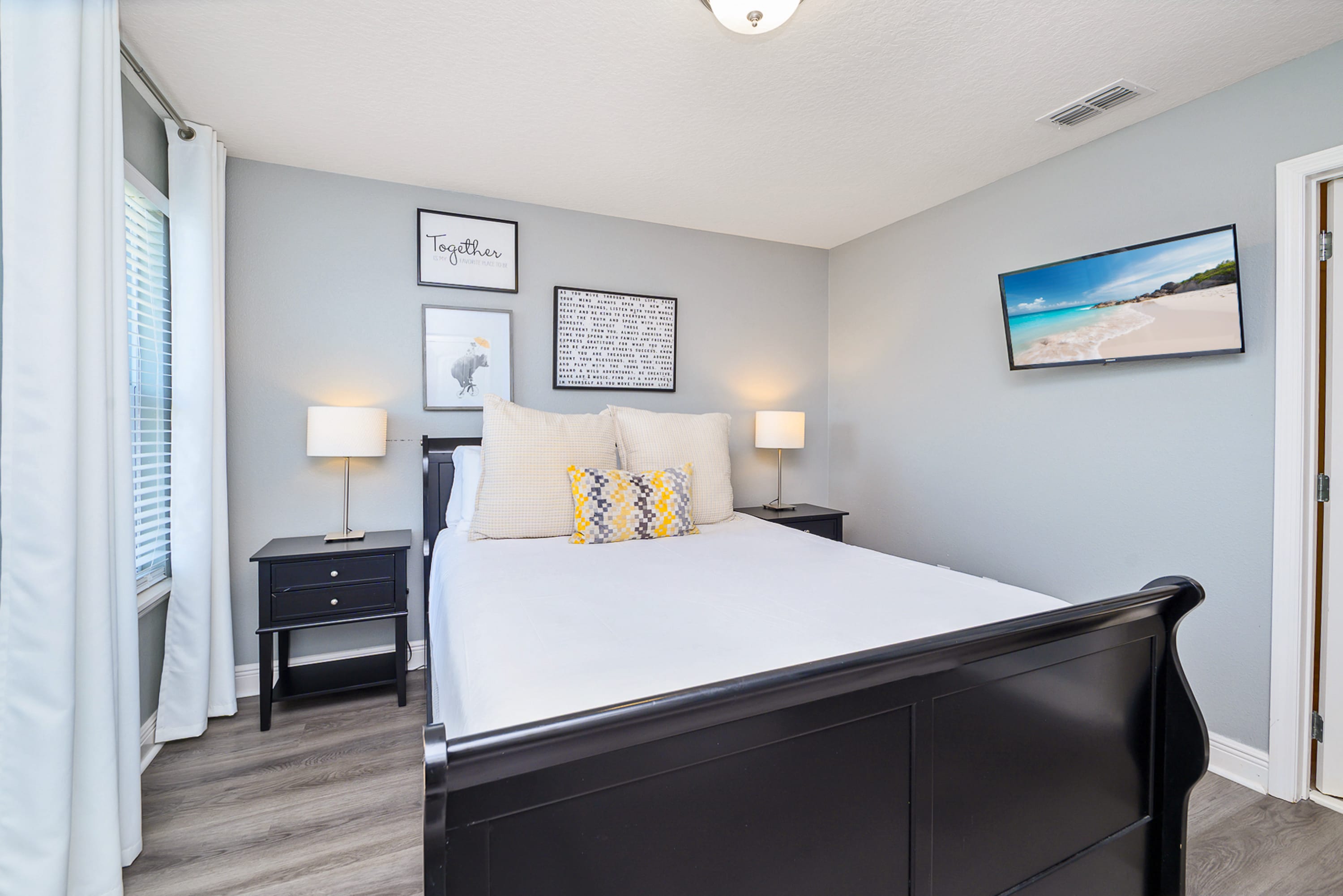 Relax In This Bright Queen Bedroom With Modern Wall Art