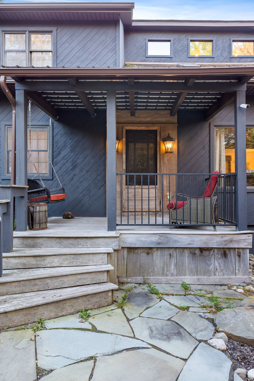 Inviting Front Porch Entryway – A stylish and cozy entrance with warm lighting and rustic decor.