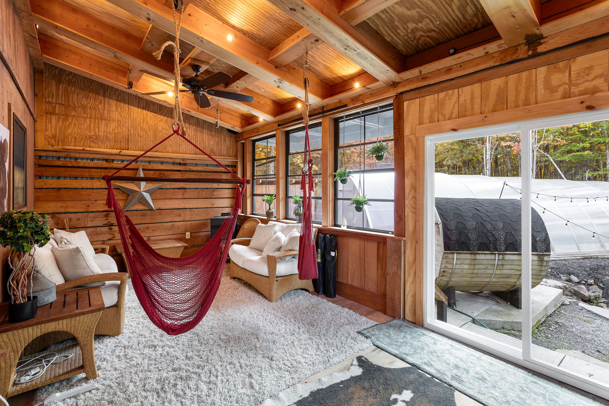 Rustic Indoor Hammock Lounge – A relaxing space with hanging hammocks and warm wooden interiors.