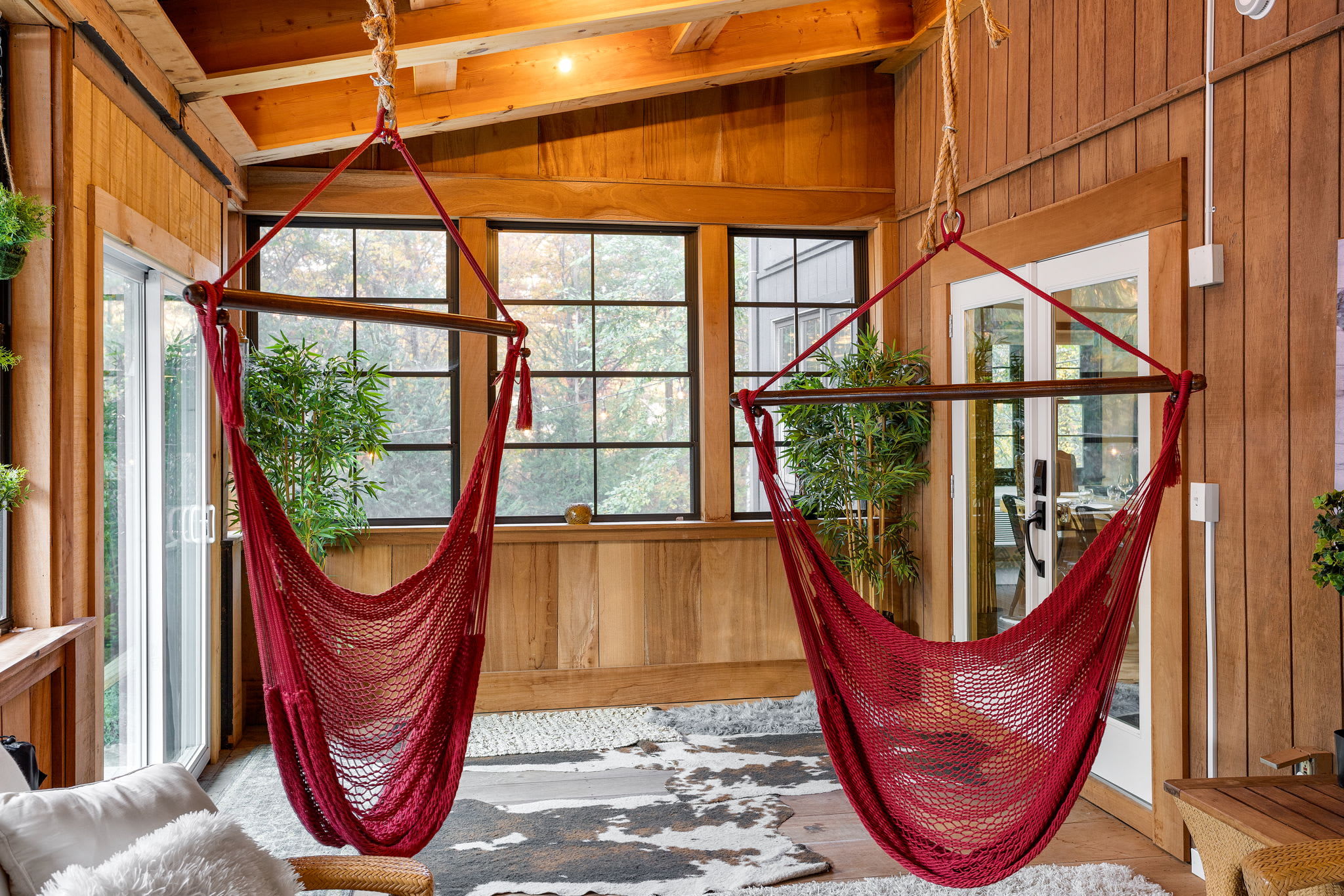 Expansive windows bring in natural light, blending indoor comfort with the serene beauty of the outdoors.