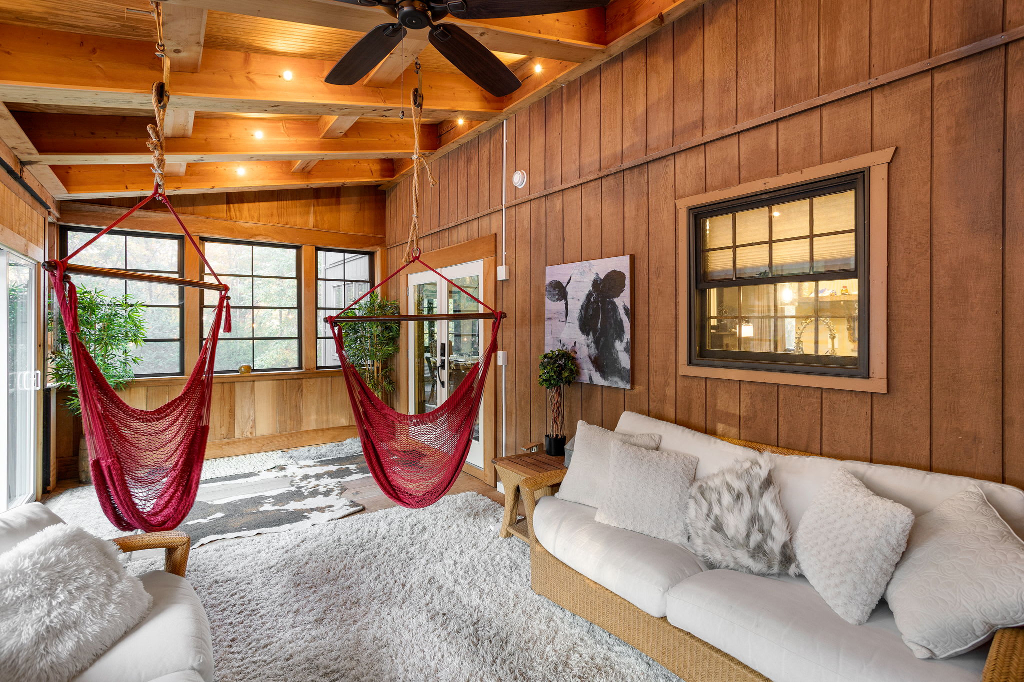 Wicker seating and plush rugs create a warm lounge area, perfect for cozy afternoons or casual gatherings.