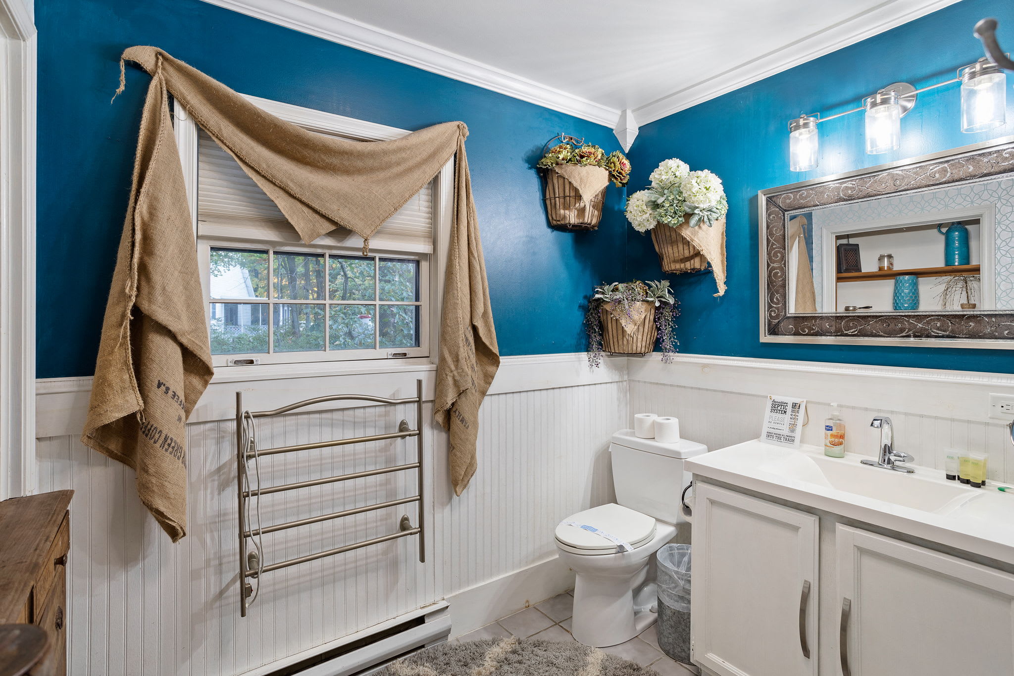 Hanging baskets of hydrangeas and burlap accents lend a rustic, whimsical touch to the space.
