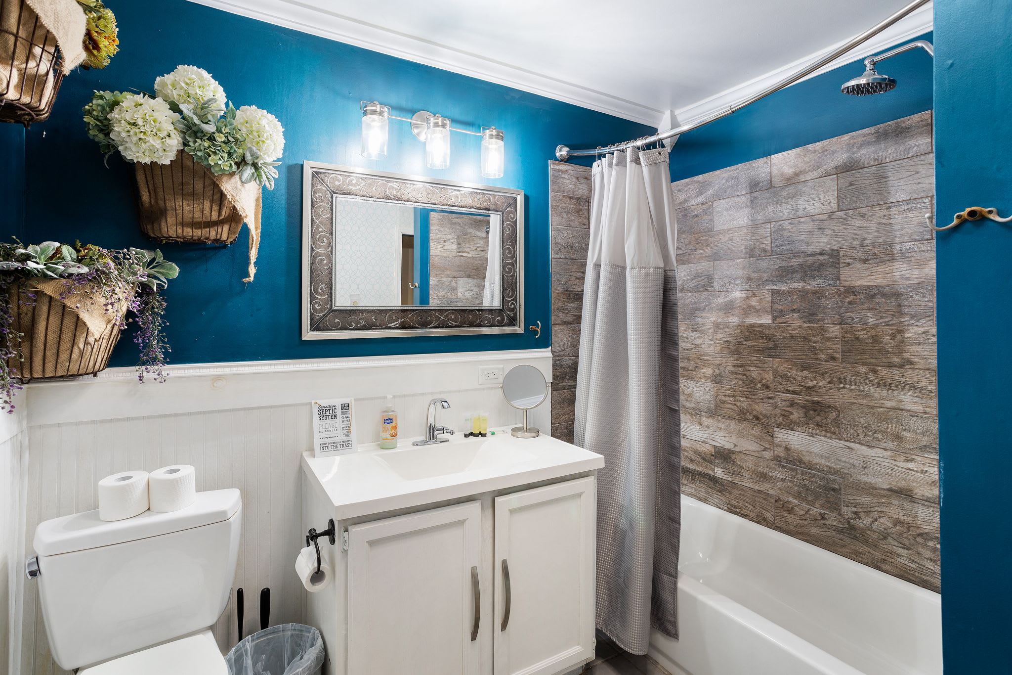 A wood-look shower surround and decorative mirror add warmth and style to your daily routine.
