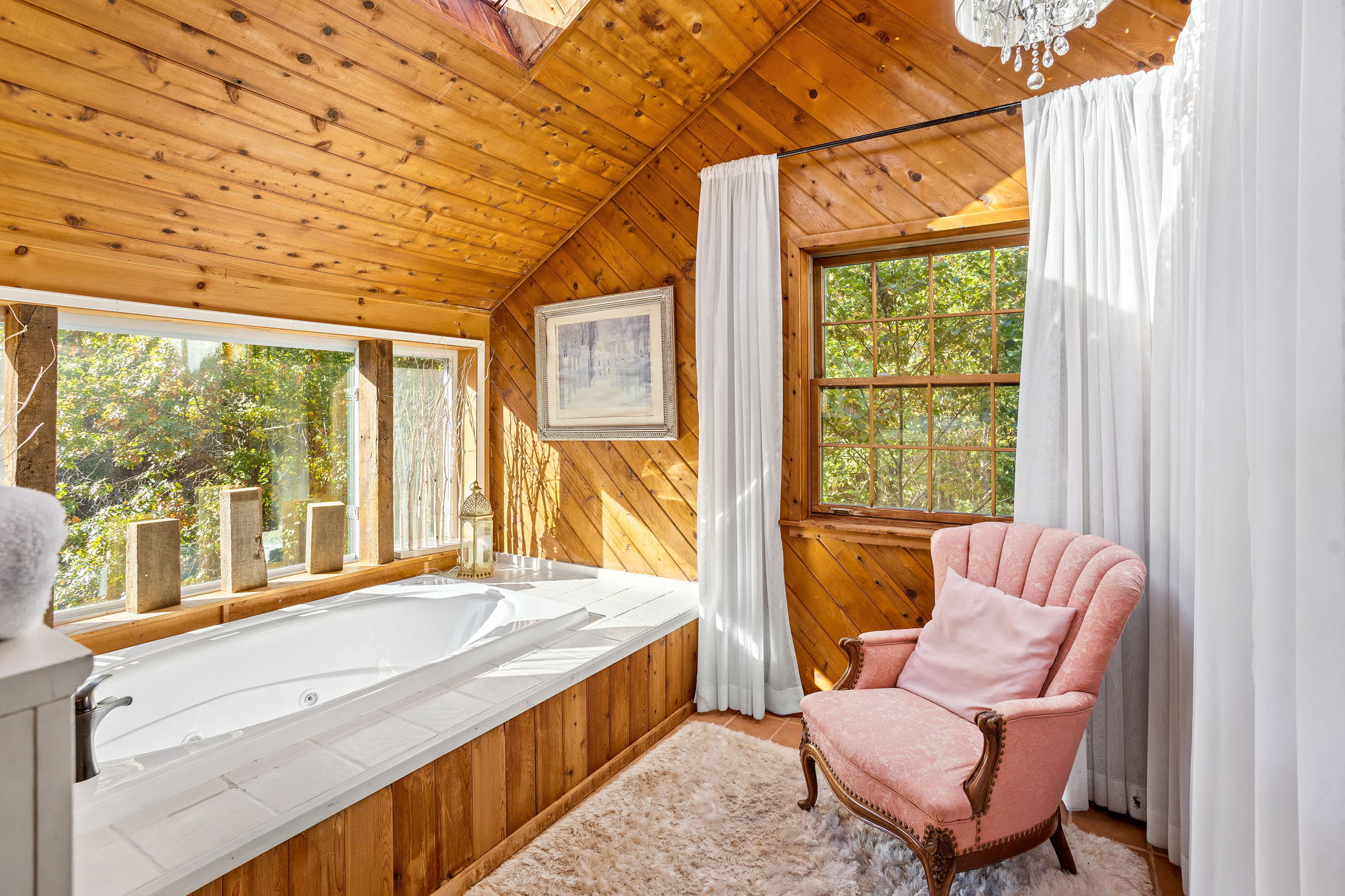 Natural light floods in, highlighting the wood’s warm hues and inviting you to unwind in peaceful comfort.
