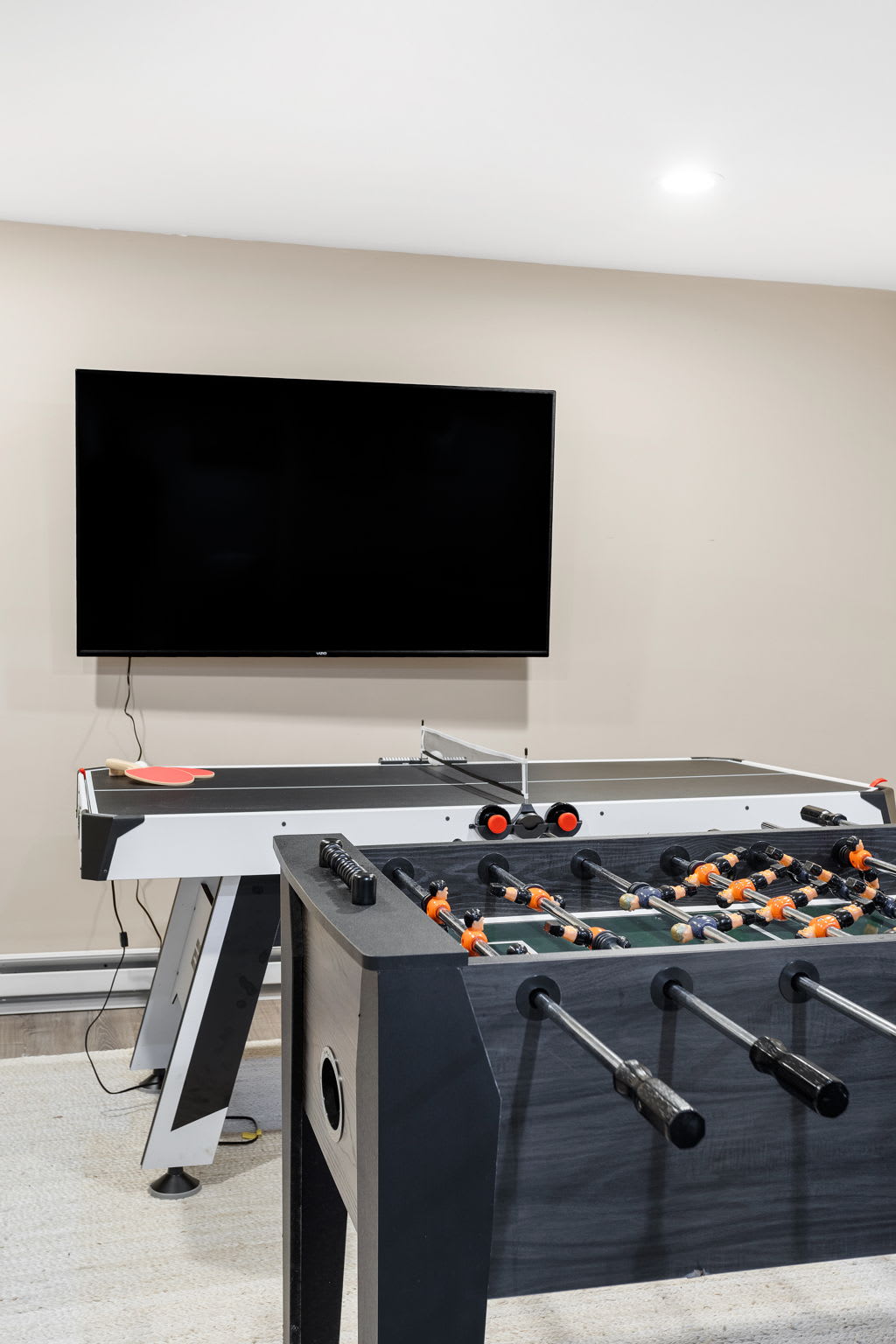 Up close, the foosball table and ping-pong surface invite you to jump right into the action, all within sight of a mounted flatscreen.