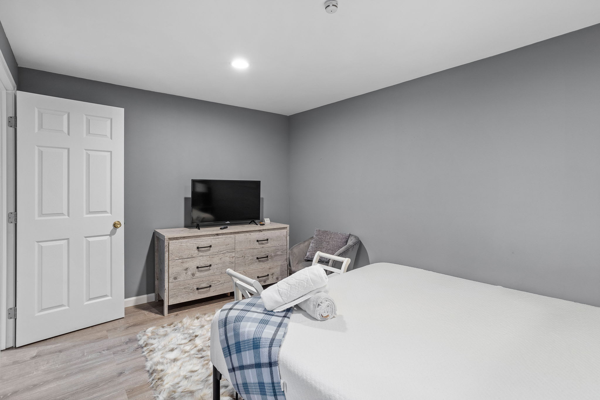 Another angle showcases the room’s clean lines and neutral palette, creating a calming spot to rest and recharge.