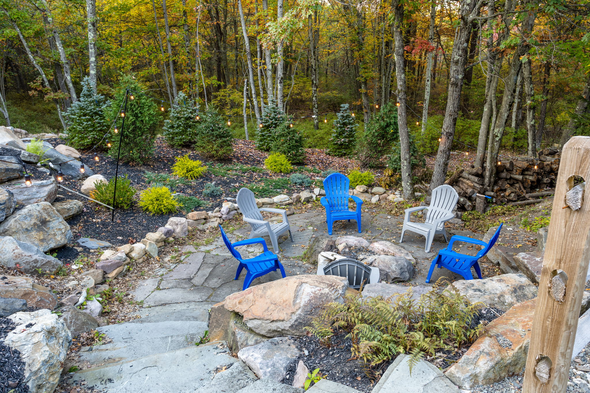 A tucked-away fire pit area with Adirondack chairs offers a peaceful spot to gather under the trees. It’s perfect for roasting marshmallows and swapping stories under the stars.