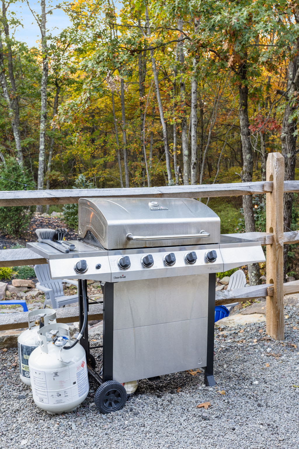 A stainless-steel grill stands by, waiting for you to fire up a hearty meal. The natural surroundings add a touch of rustic charm to your outdoor cooking experience.