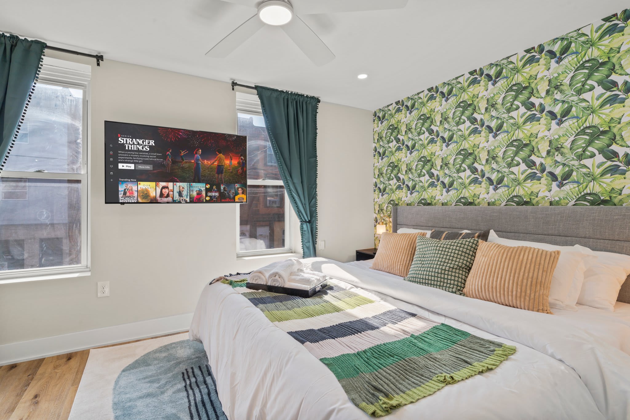Rest and relax in this beautifully decorated bedroom! You’ll adore the lush, tropical wallpaper, plush pillows, and cozy bedding. This serene retreat is perfect for unwinding and ensuring a restful night's sleep.