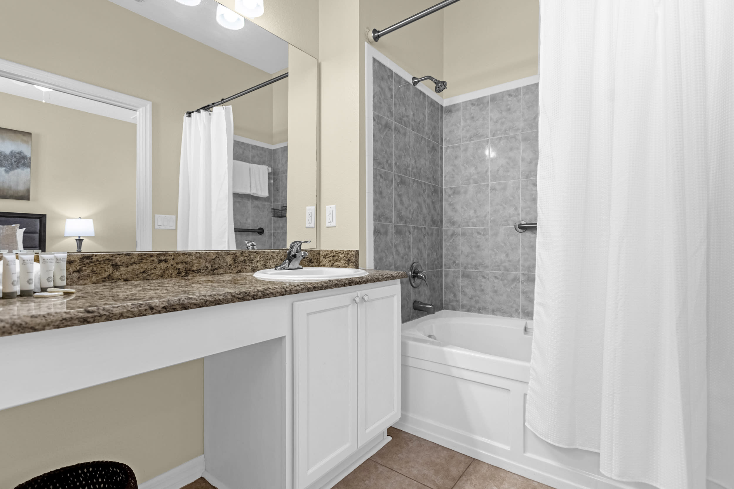 Queen bedroom ensuite bathroom with shower-in-tub design.