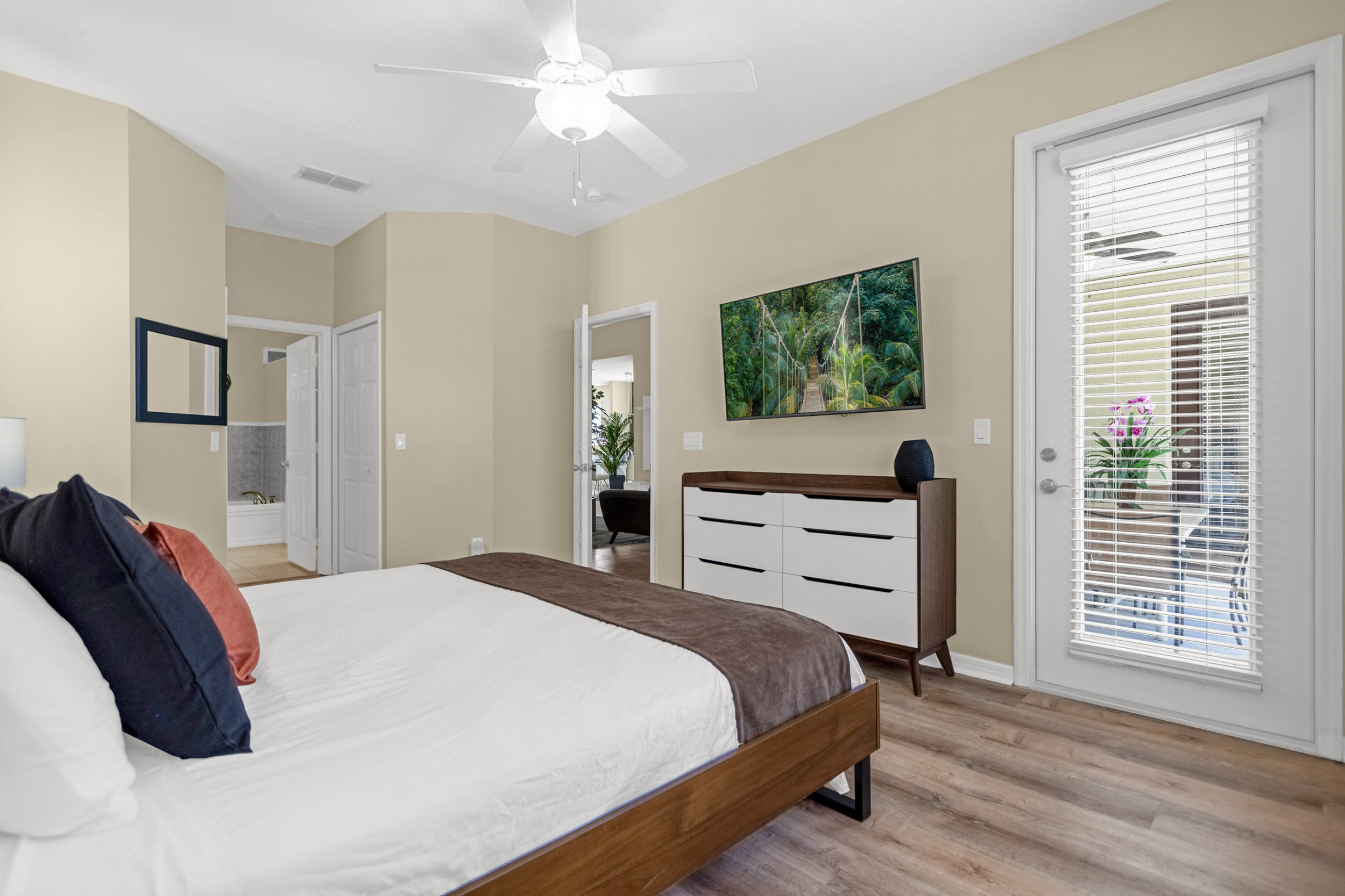Primary bedroom has direct patio access, a smart TV, and ensuite bathroom.