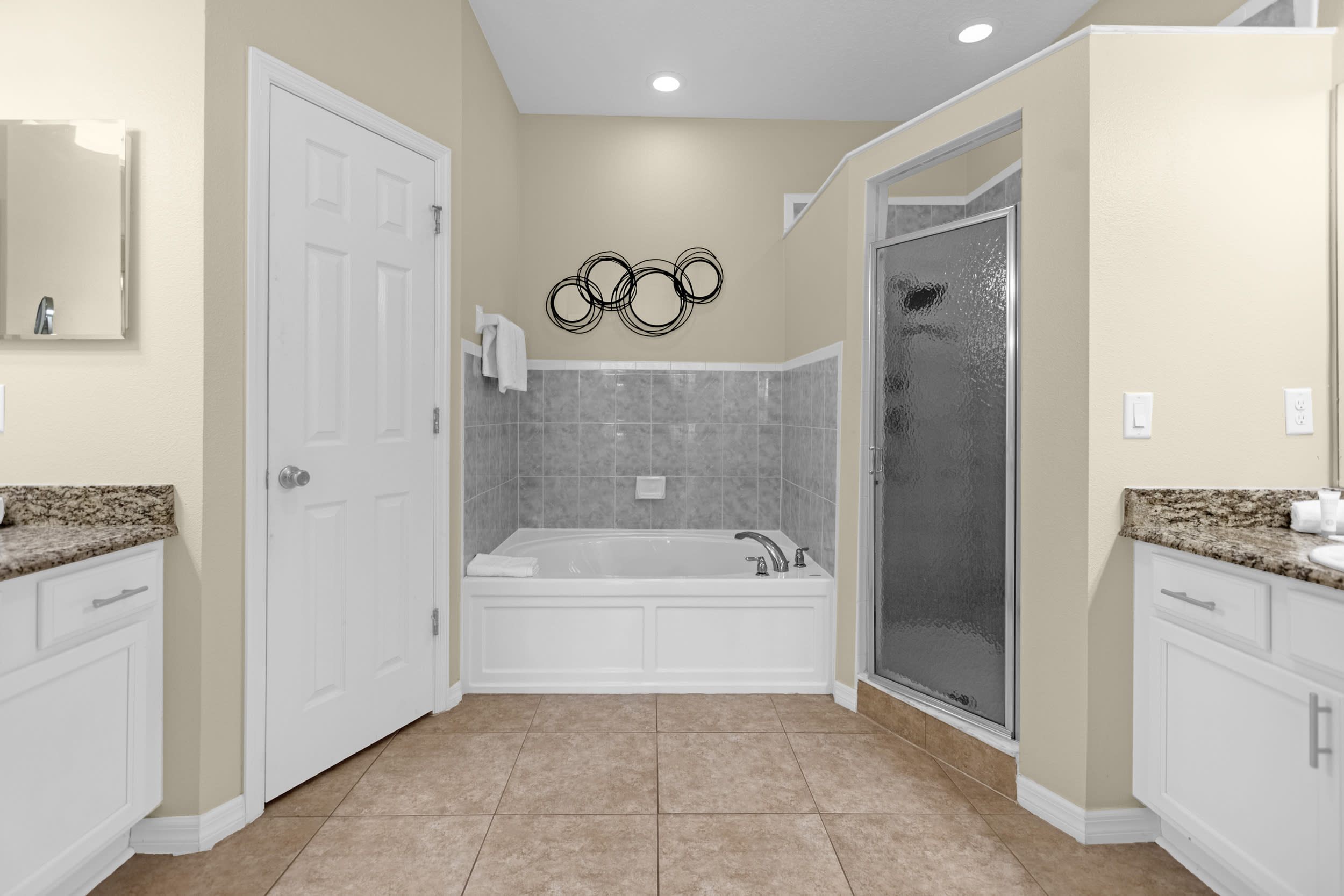 Spacious ensuite bathroom has a spa-like soaker bathtub, and a large walk-in shower