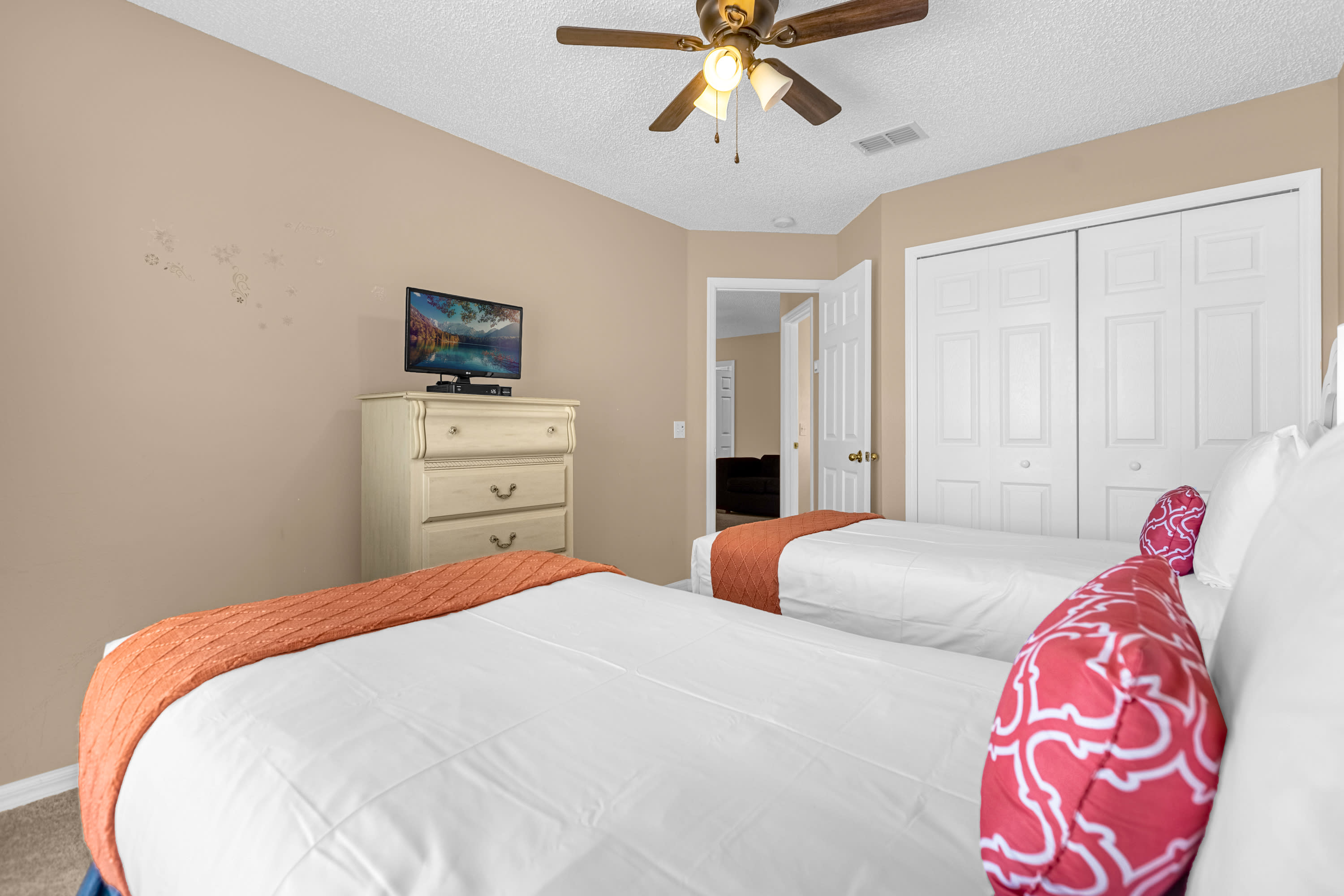 Twin Bedroom With Vibrant Decor And Plenty Of Natural Light