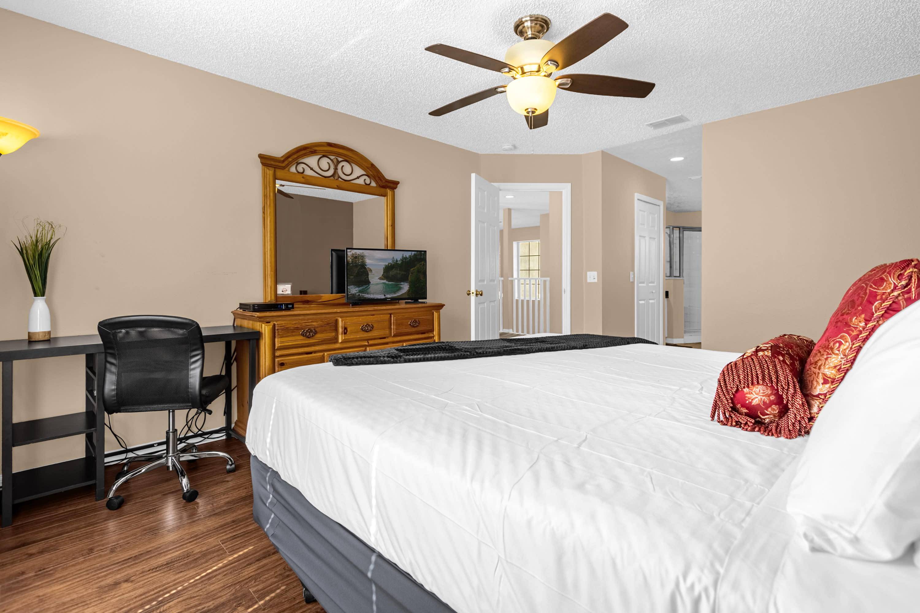 Master Bedroom With King Bed, Ample Lighting, And Workstation