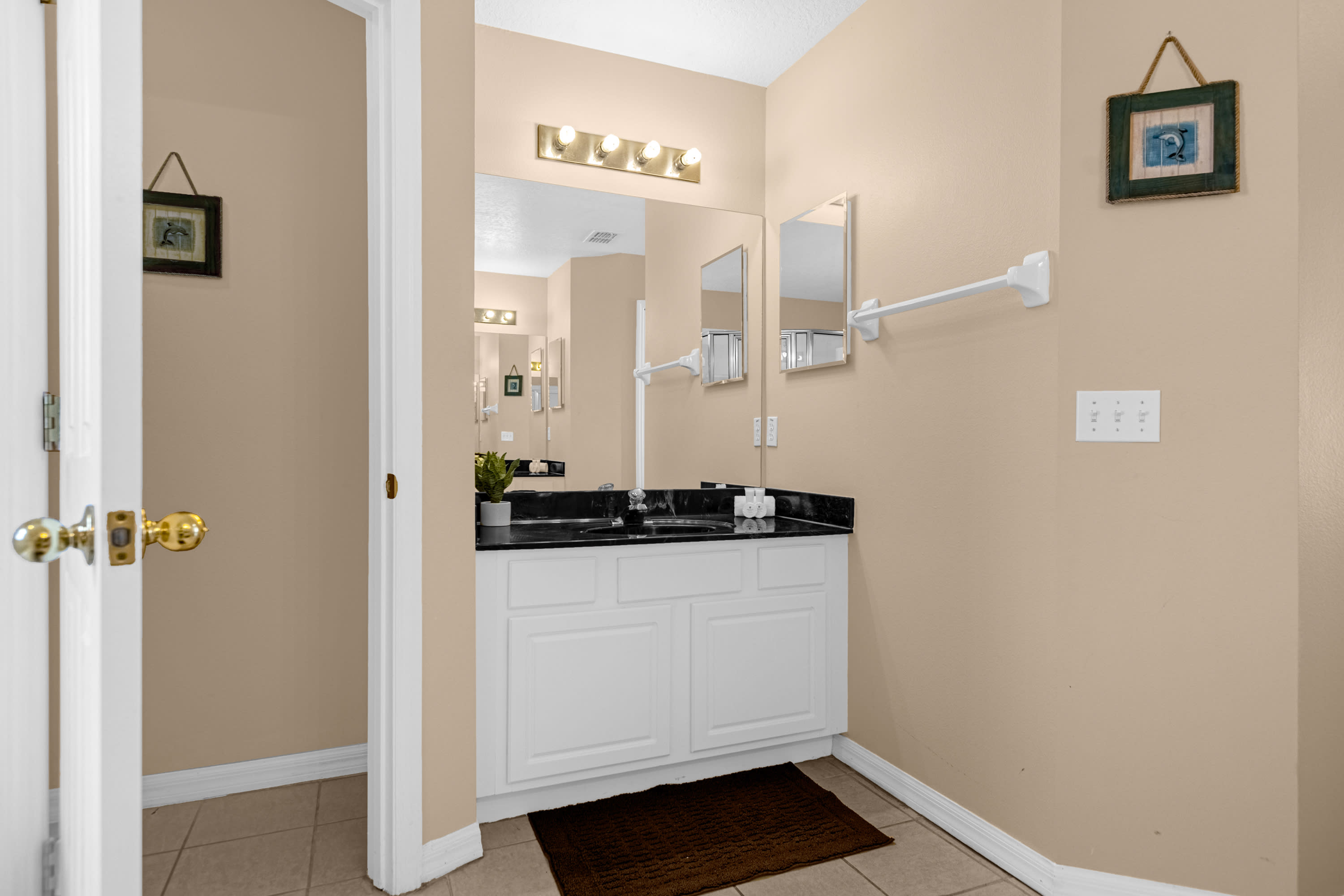 Spacious Bathroom With Large Mirrors And Elegant Design