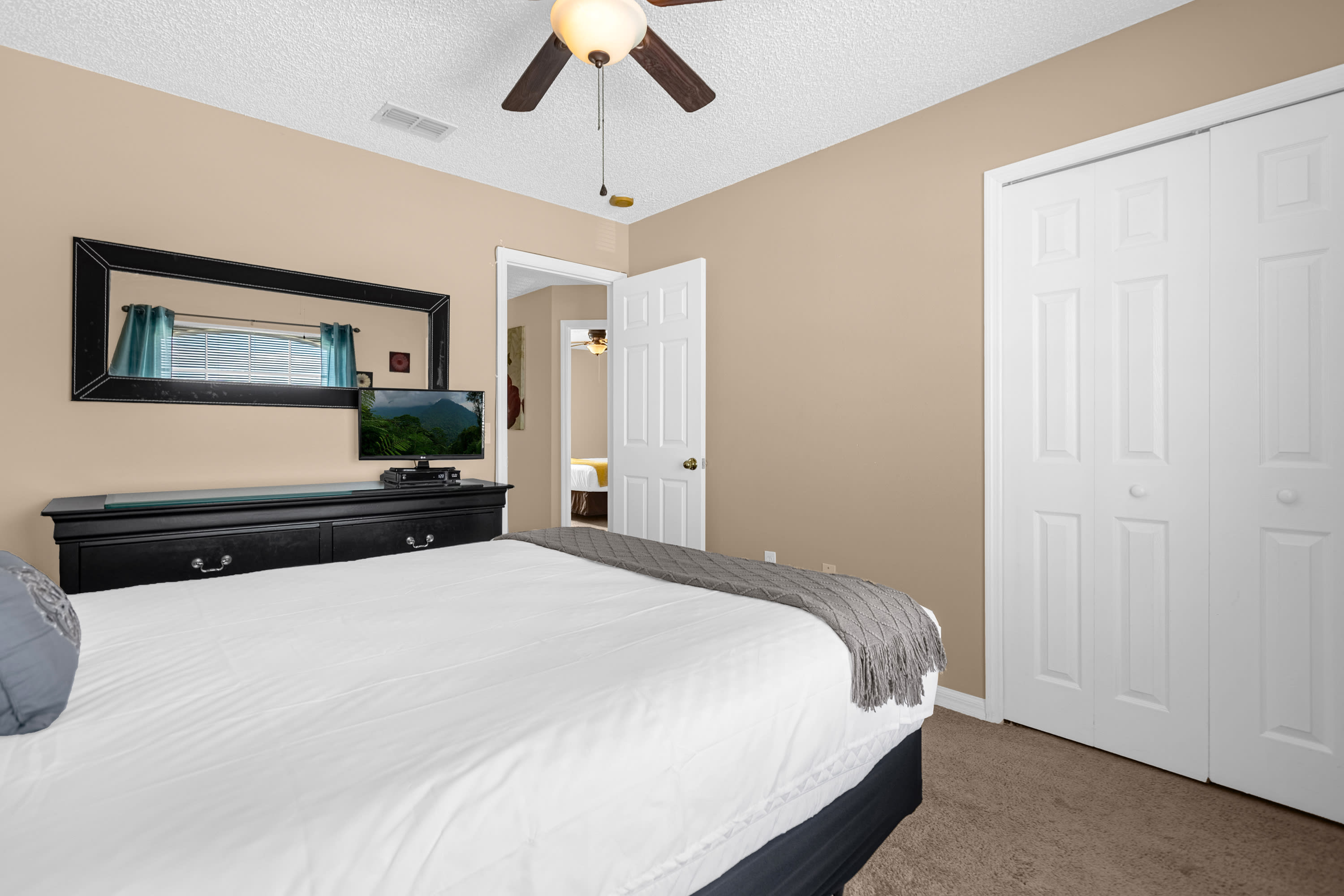 Stylish Bedroom Featuring Comfortable Bedding And Warm Tones