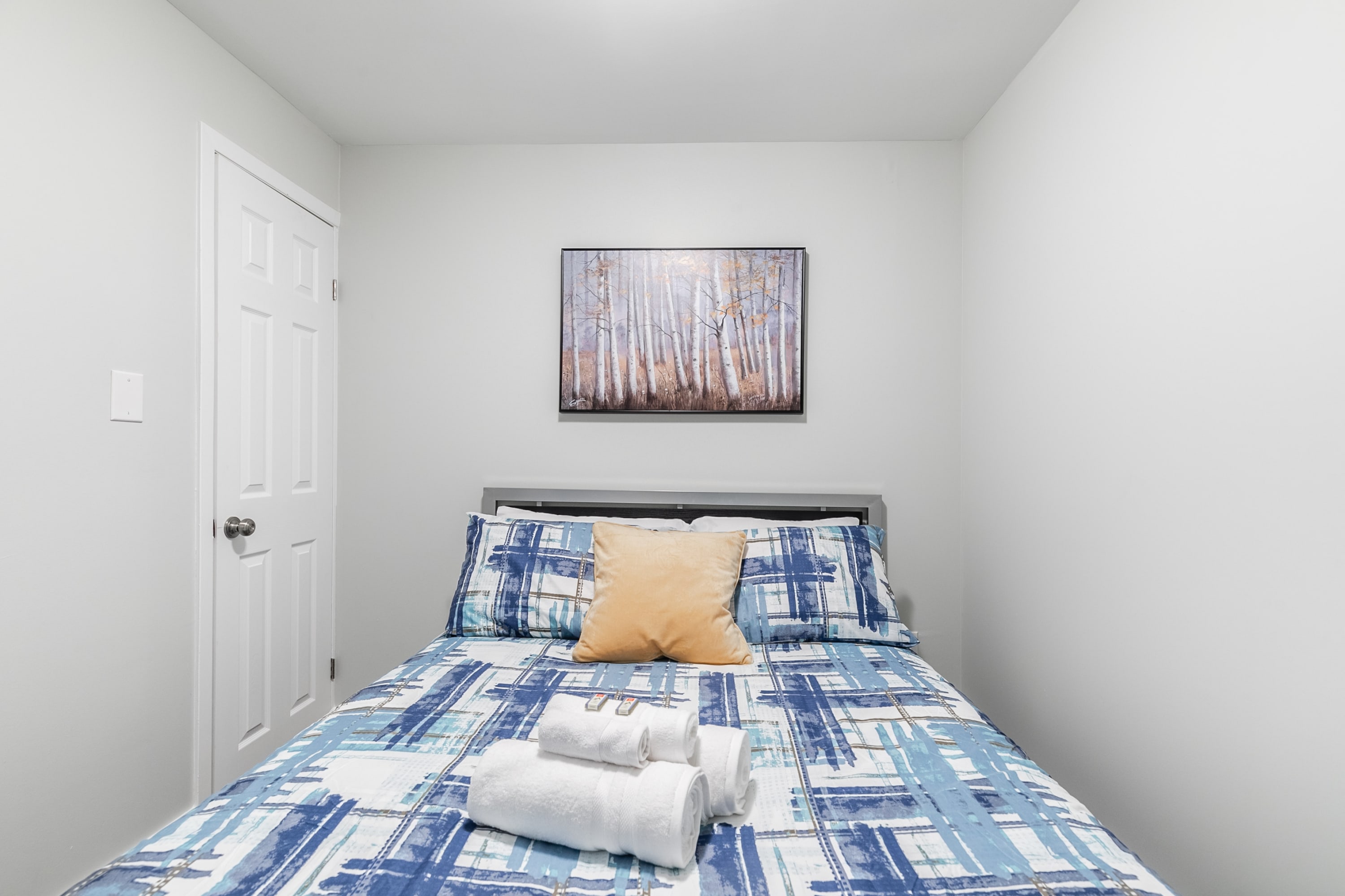 Spacious Bedroom With A Queen Bed And Vibrant Bedding