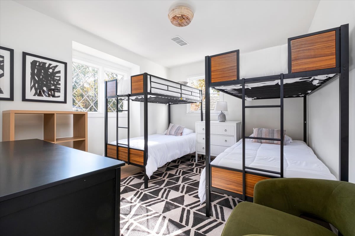 This bedroom features 4 twin beds and a Smart TV