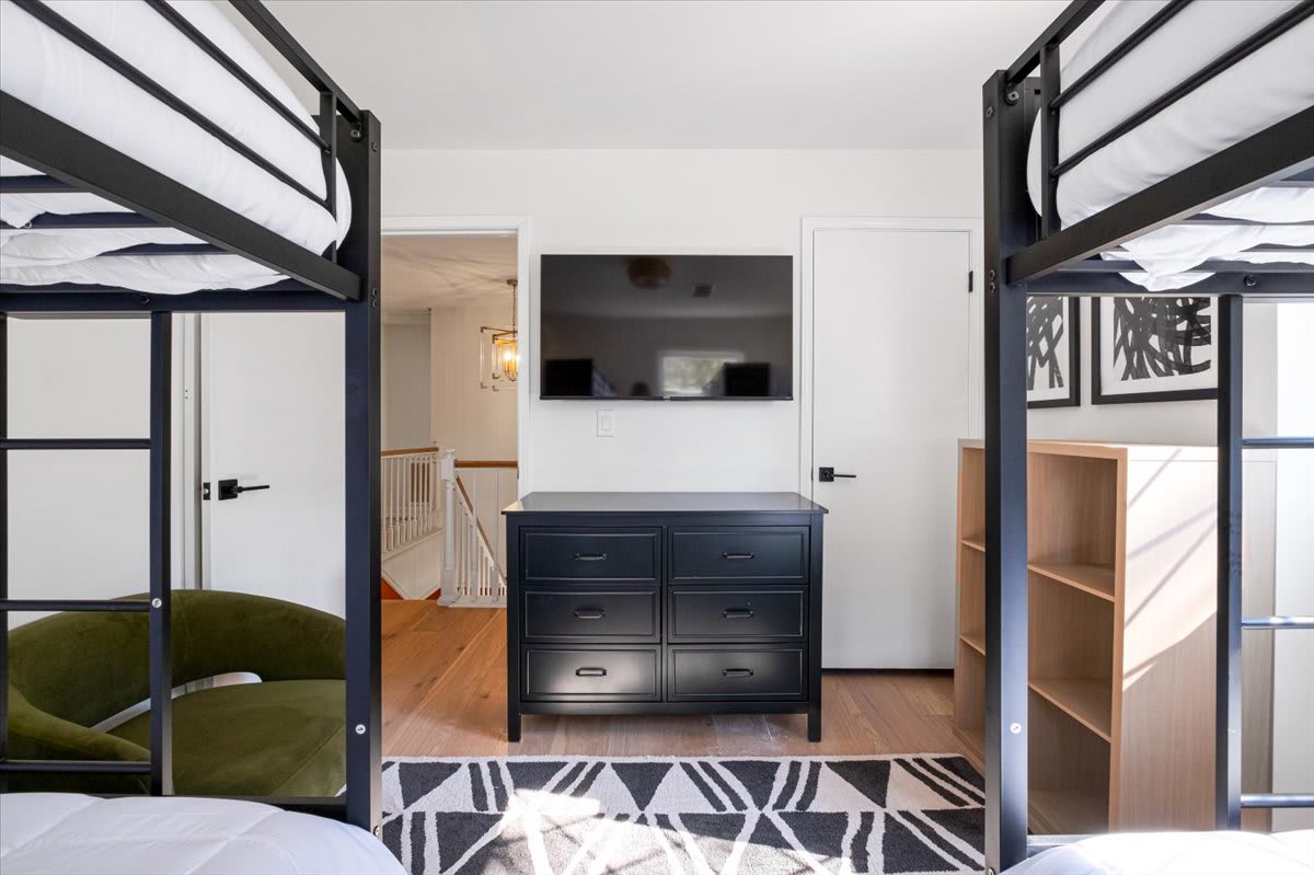 This bedroom features 4 twin beds and a Smart TV