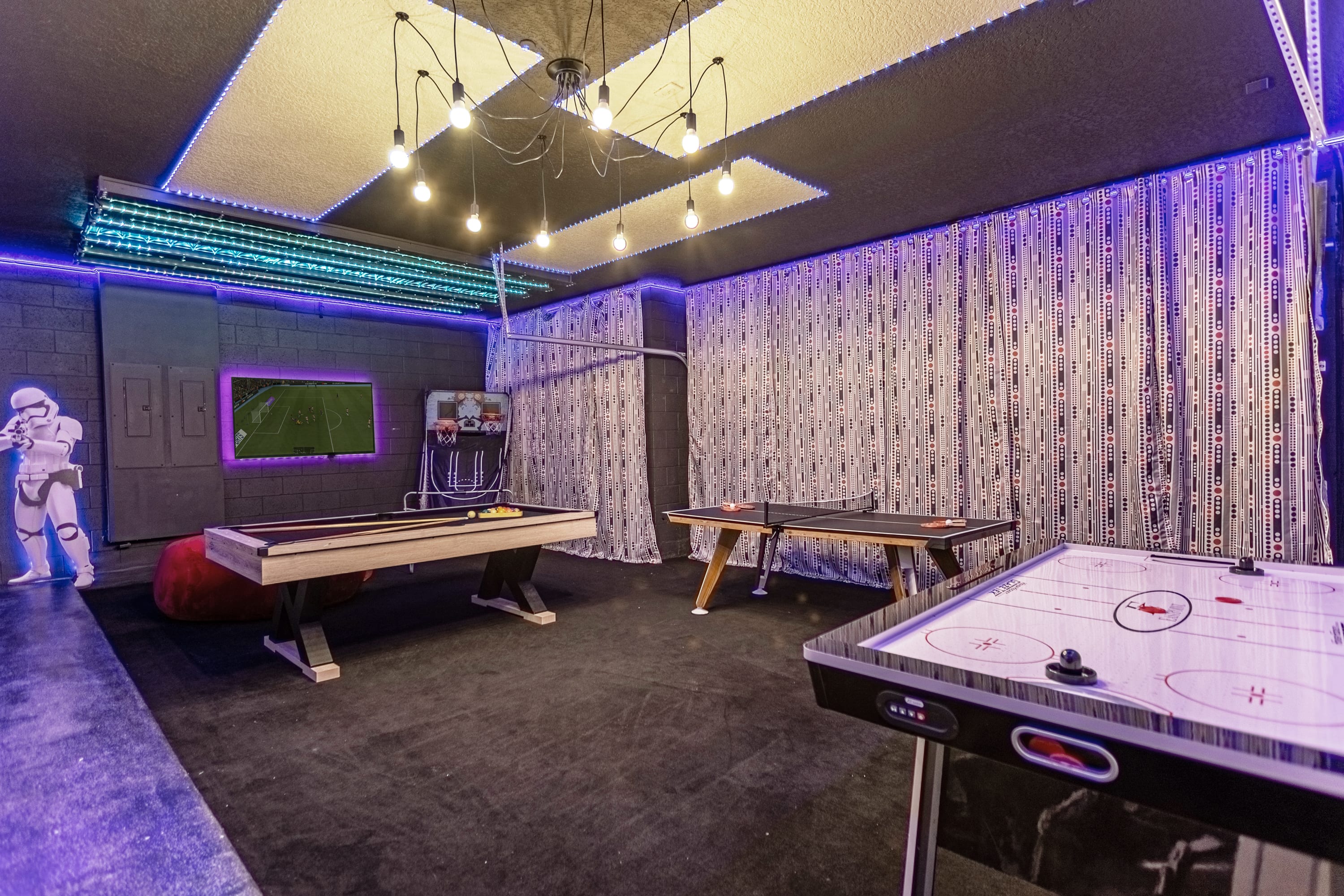Garage-turned-games-room with air hockey, table tennis and billiards