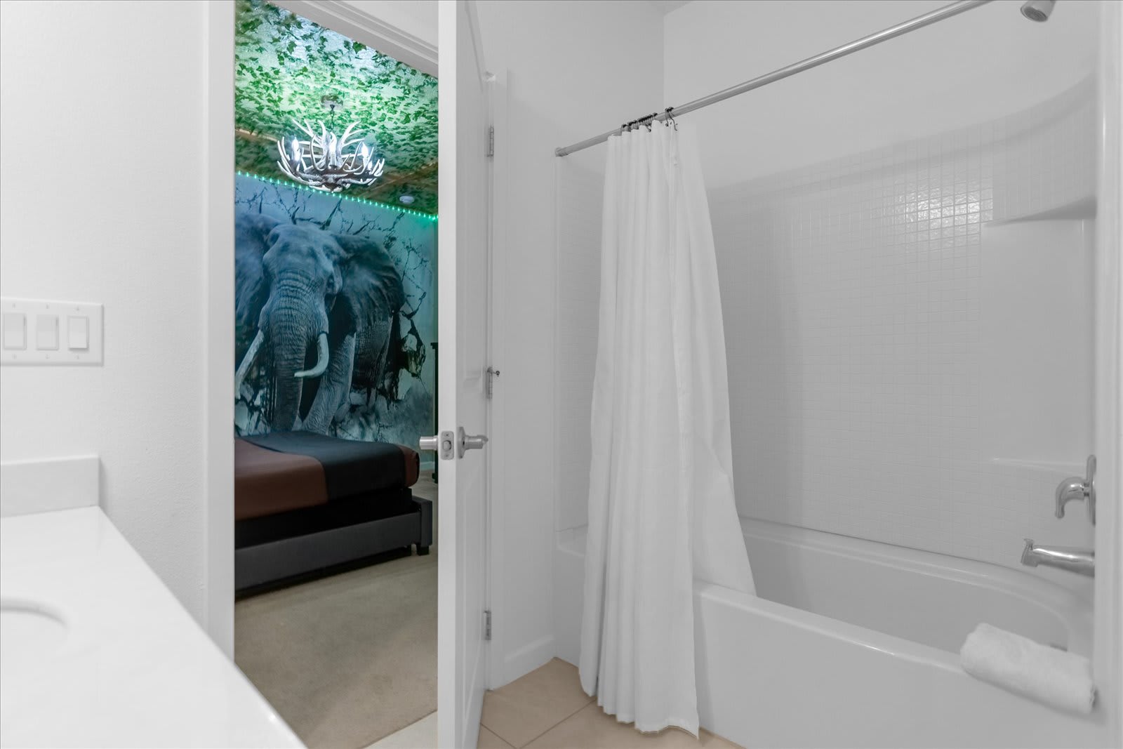 Bright And Modern Bathroom Featuring A Bathtub And Sleek White Finishes