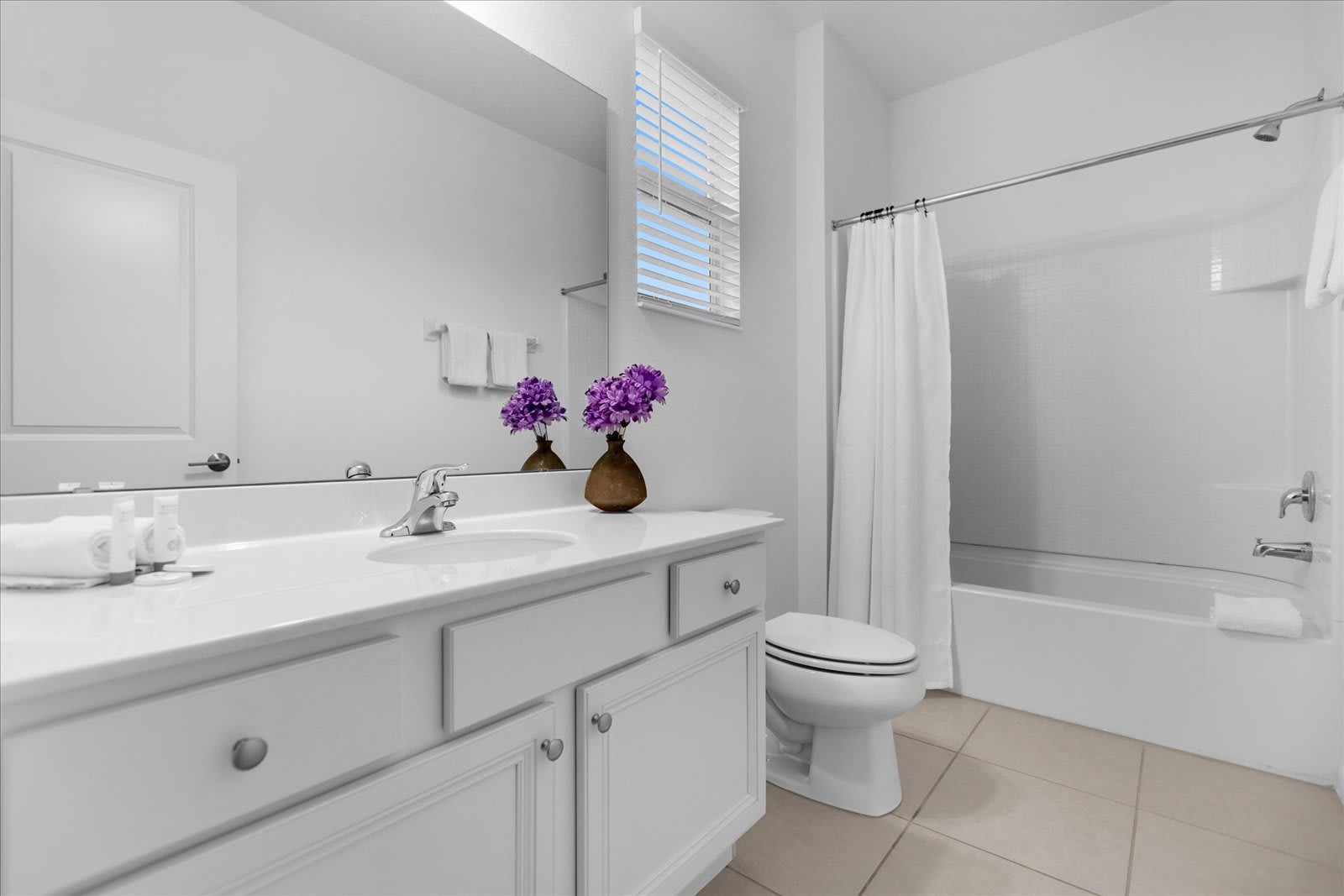 Refresh In This Bright Bathroom Featuring Sleek White Finishes