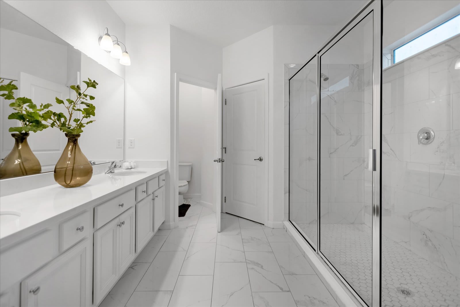 Modern Bathroom Featuring A Glass-Enclosed Shower And Sleek Fixtures