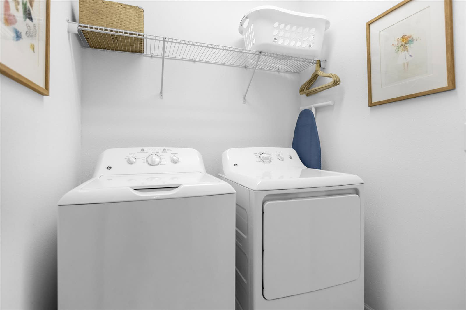 Convenient Laundry Room Featuring A Washer, Dryer, And Ample Storage