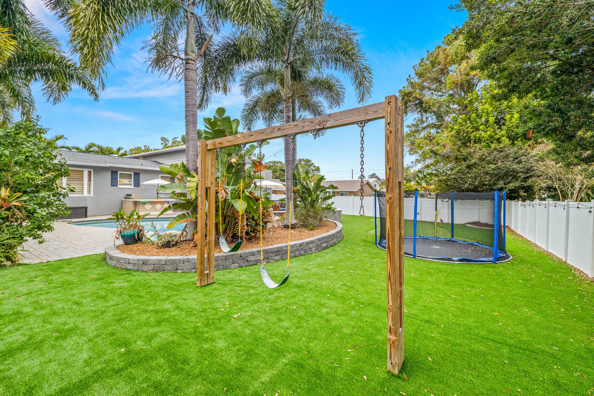 Dream backyard with swing set and in-ground trampoline!