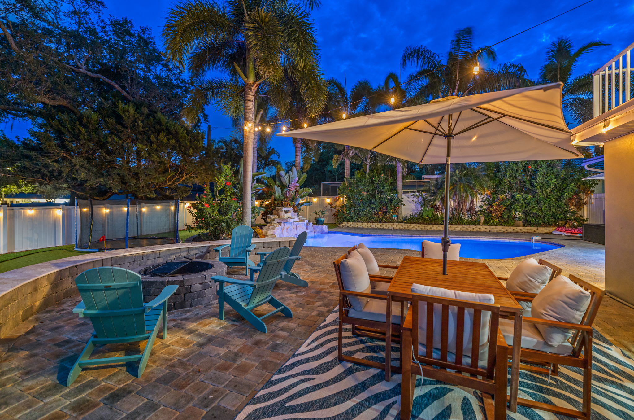 Dream backyard with swing set and in-ground trampoline!