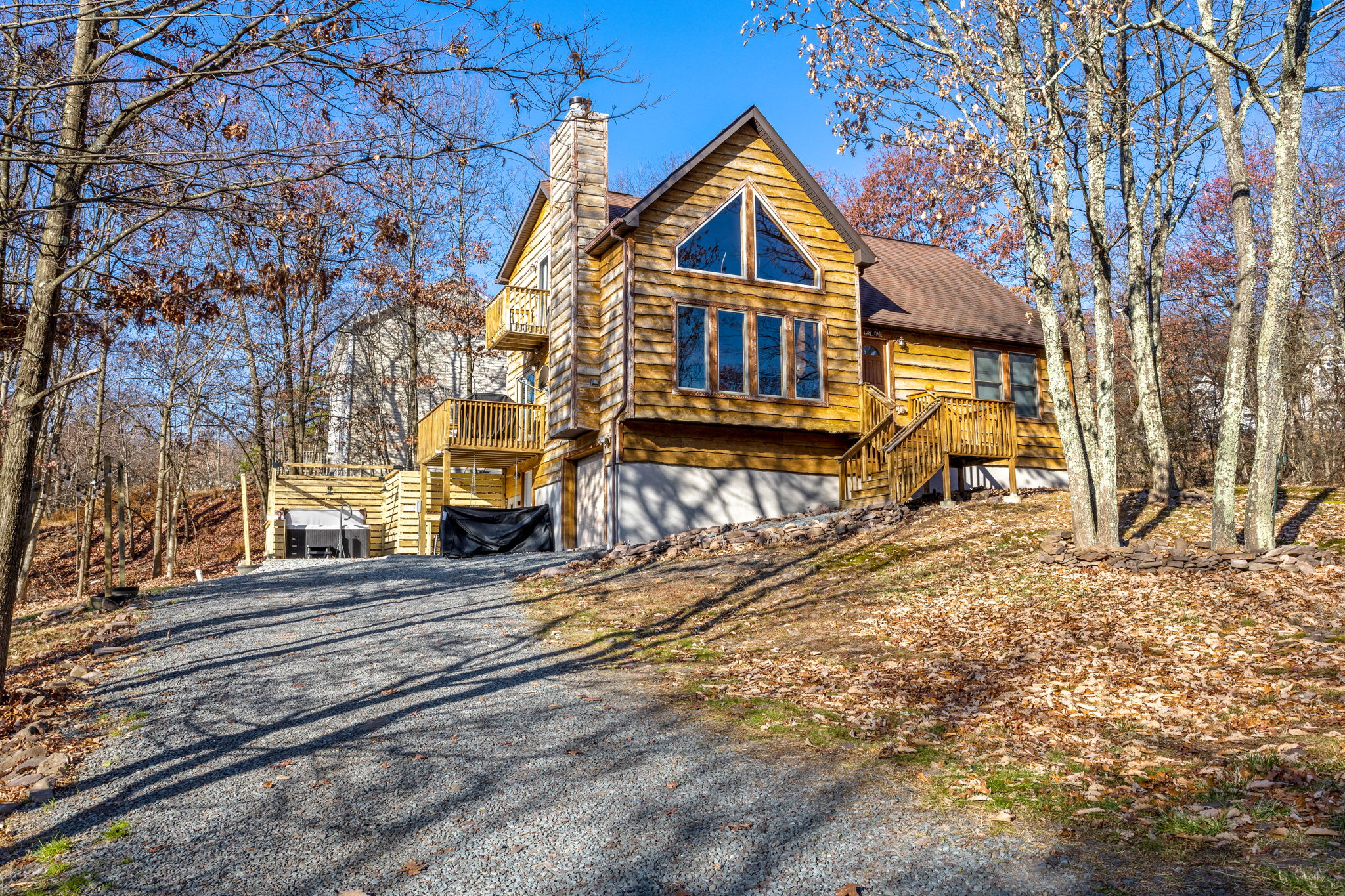 A winding gravel driveway leads up to this inviting cabin, offering a quiet escape from the everyday hustle.