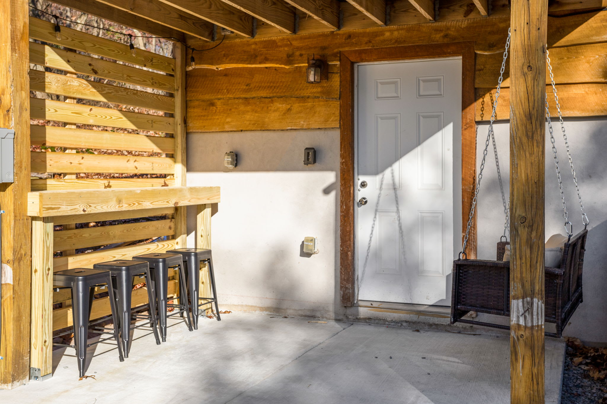 This inviting outdoor space combines rustic charm with modern comfort, offering the perfect setting for outdoor lounging.

