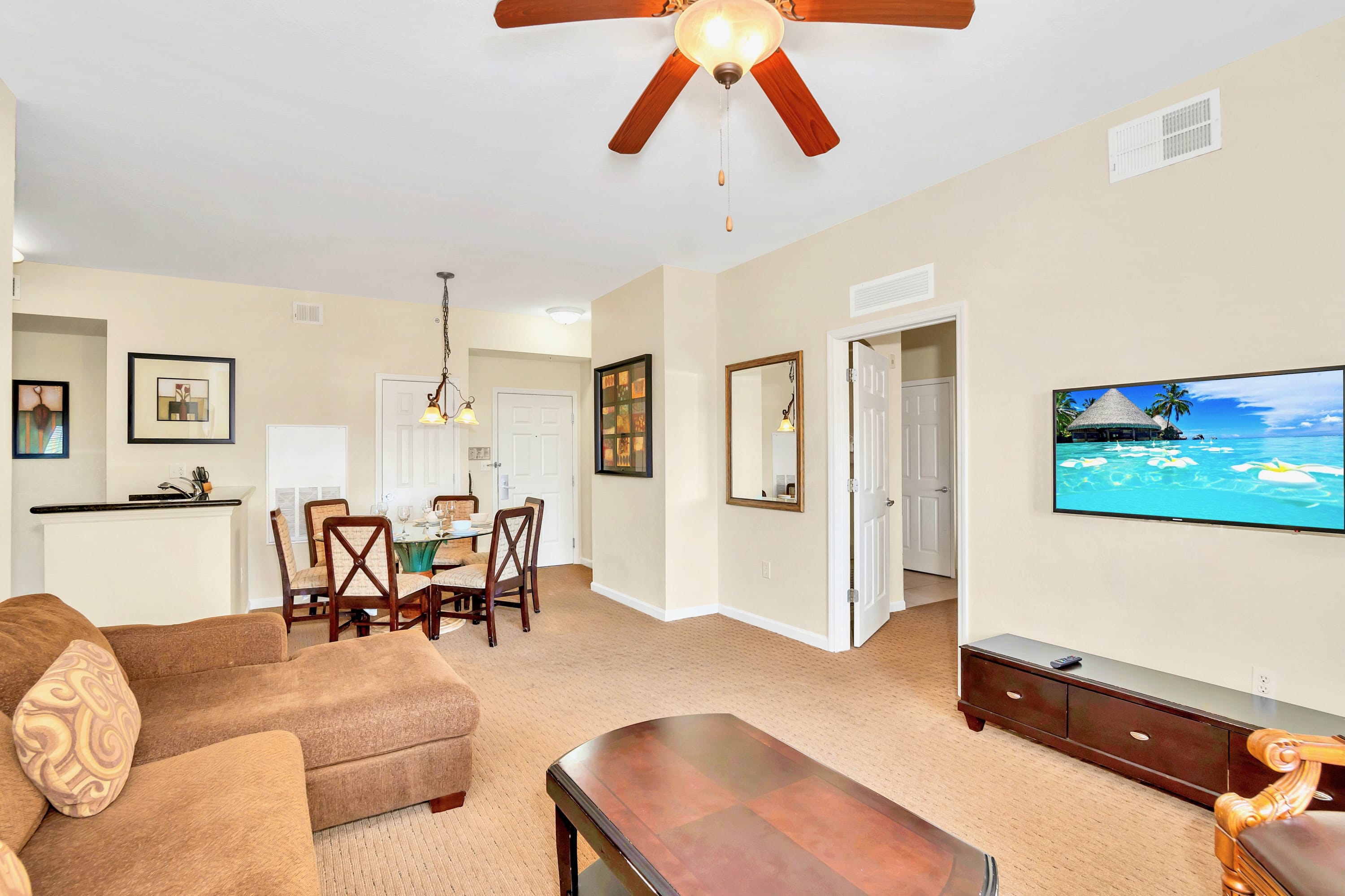 Warm And Inviting Living Room With Dining Space And Patio Access