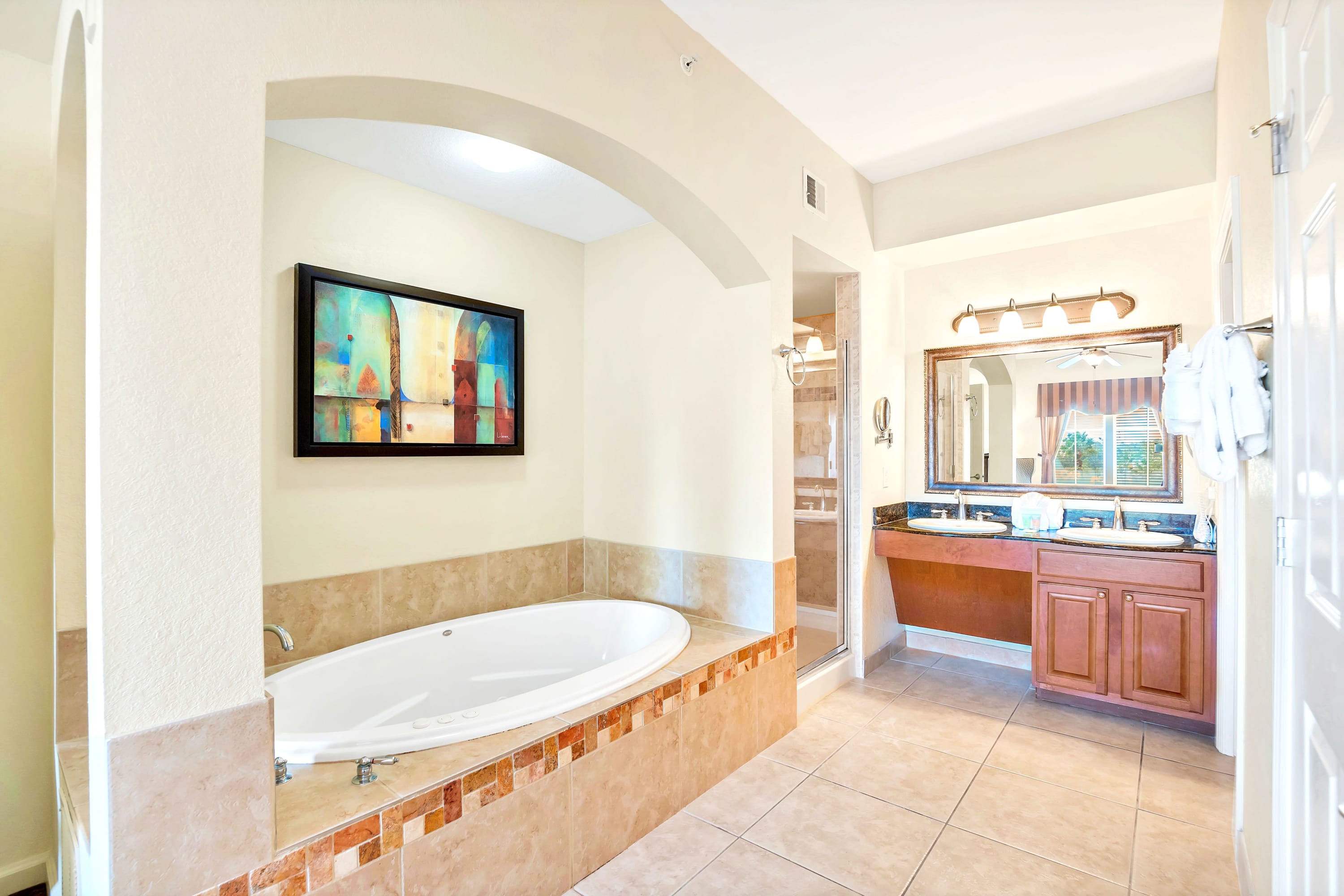 Elegant Bathroom With Dual Vanity And Jacuzzi Tub In View