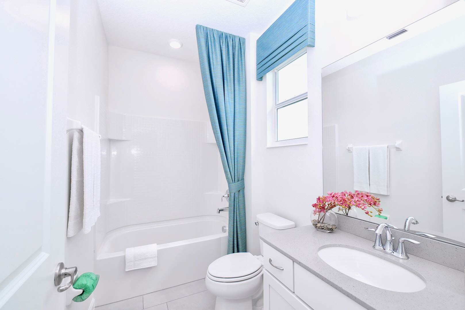 Functional Bathroom Featuring A Spacious Vanity And Fresh Linens