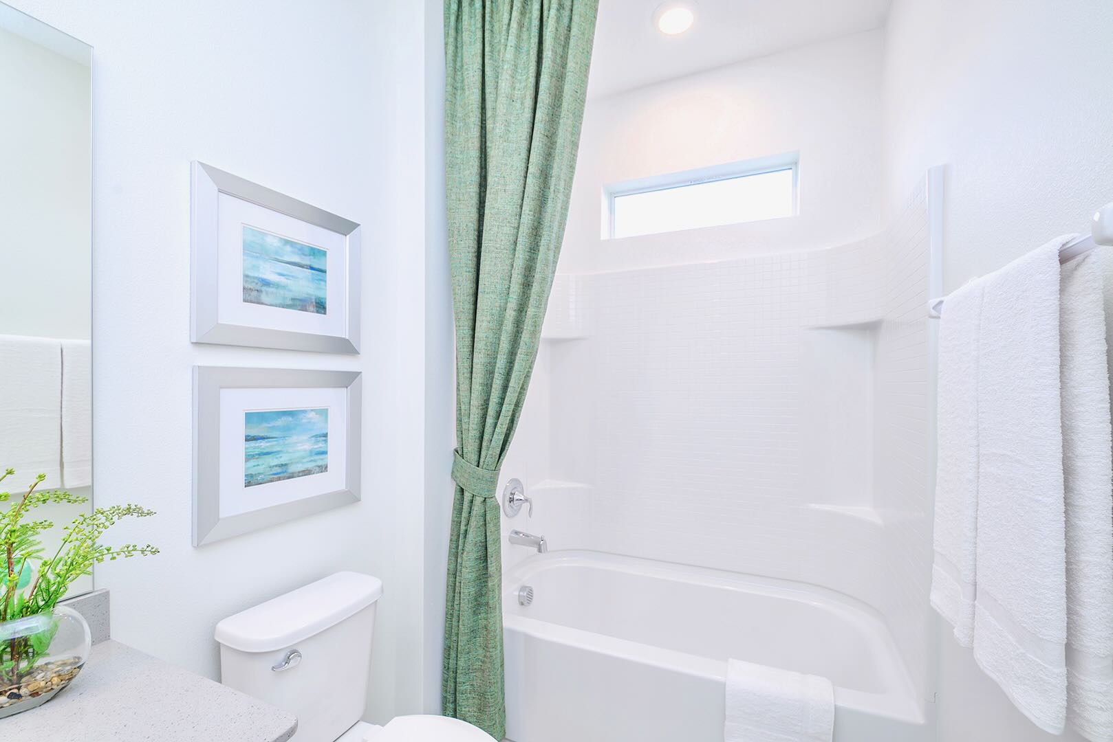 Functional Bathroom Featuring A Spacious Vanity And Fresh Linens