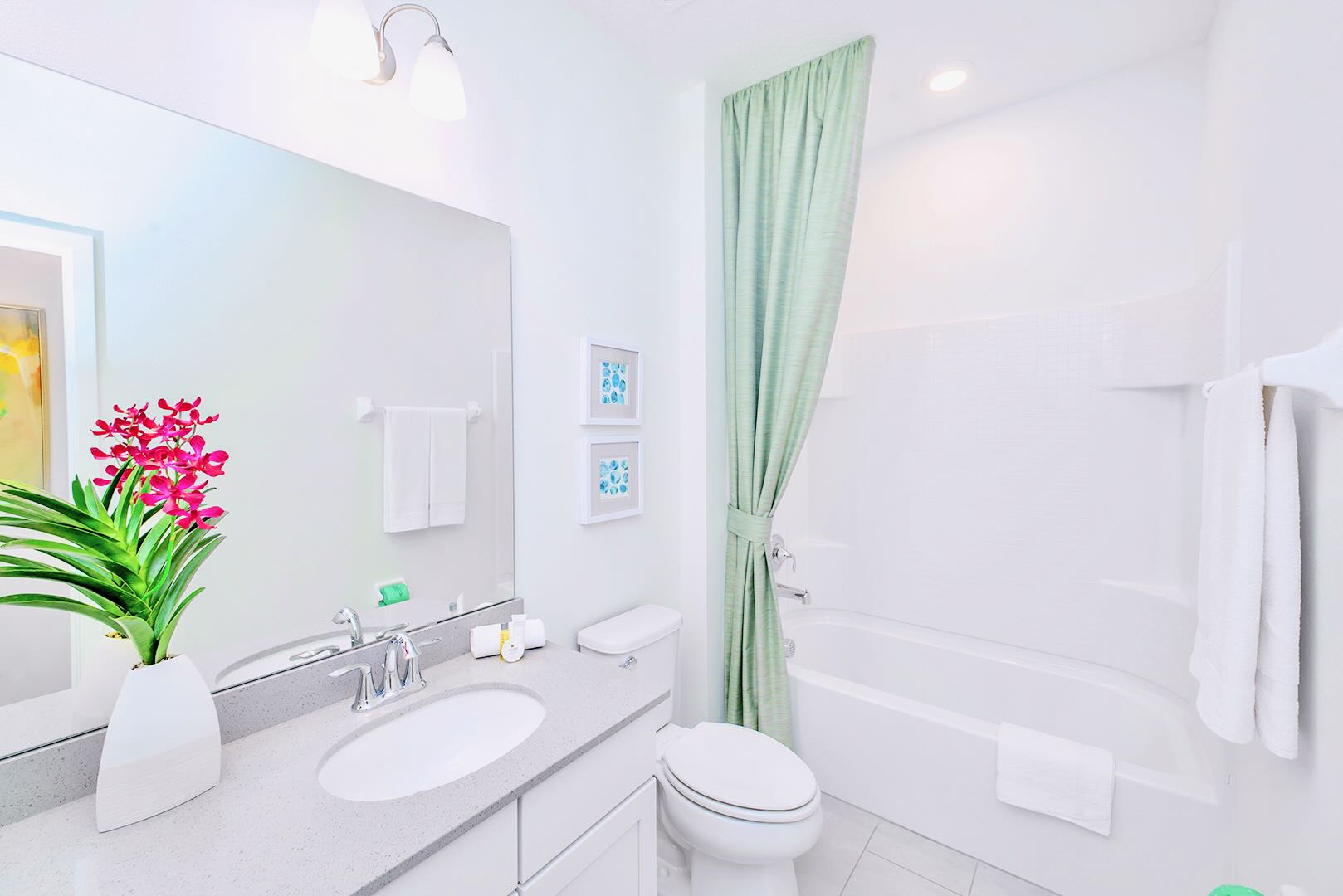 Functional Bathroom Featuring A Spacious Vanity And Fresh Linens