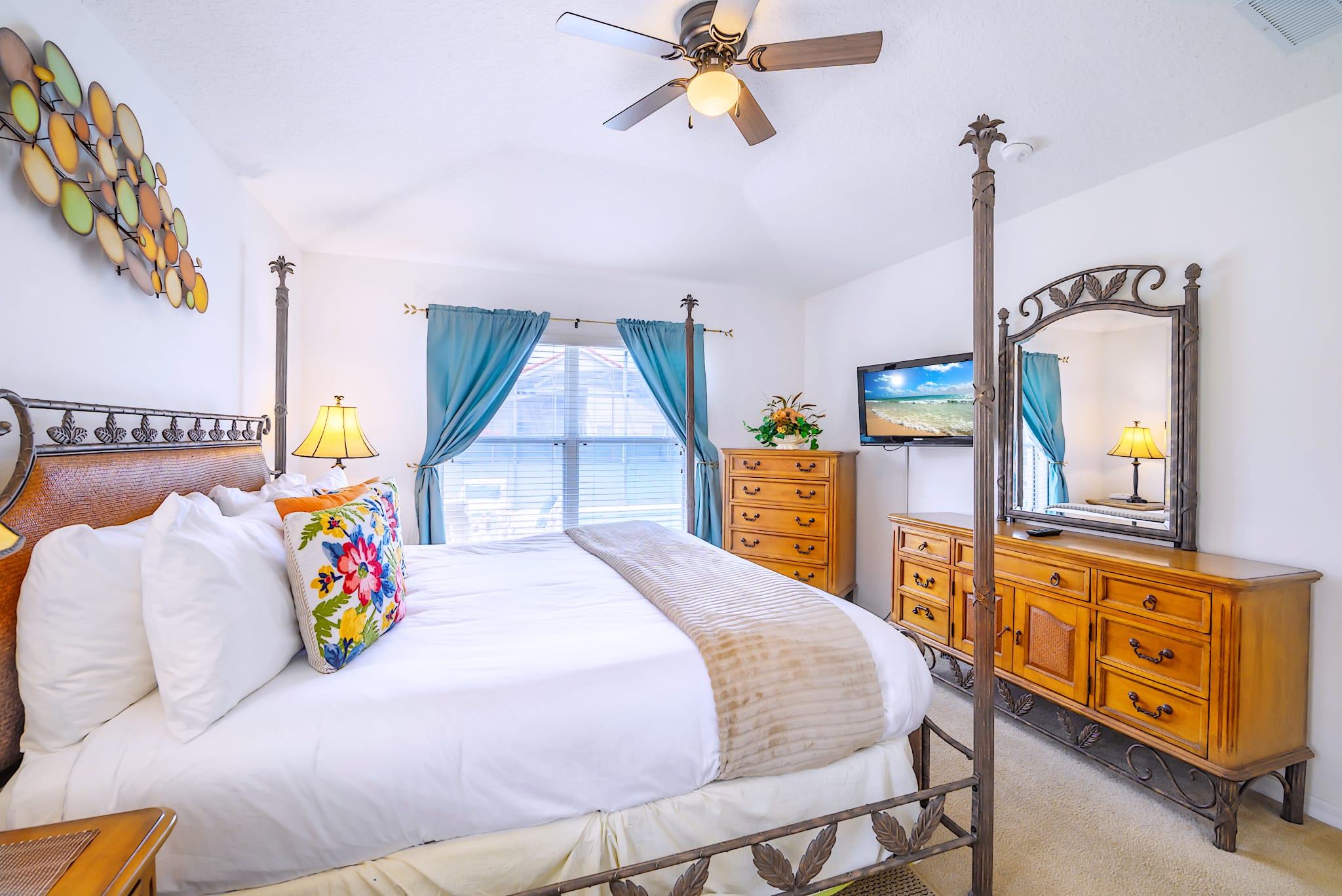 Charming Bedroom With A Ceiling Fan, Smart TV, And Elegant Rustic Accents