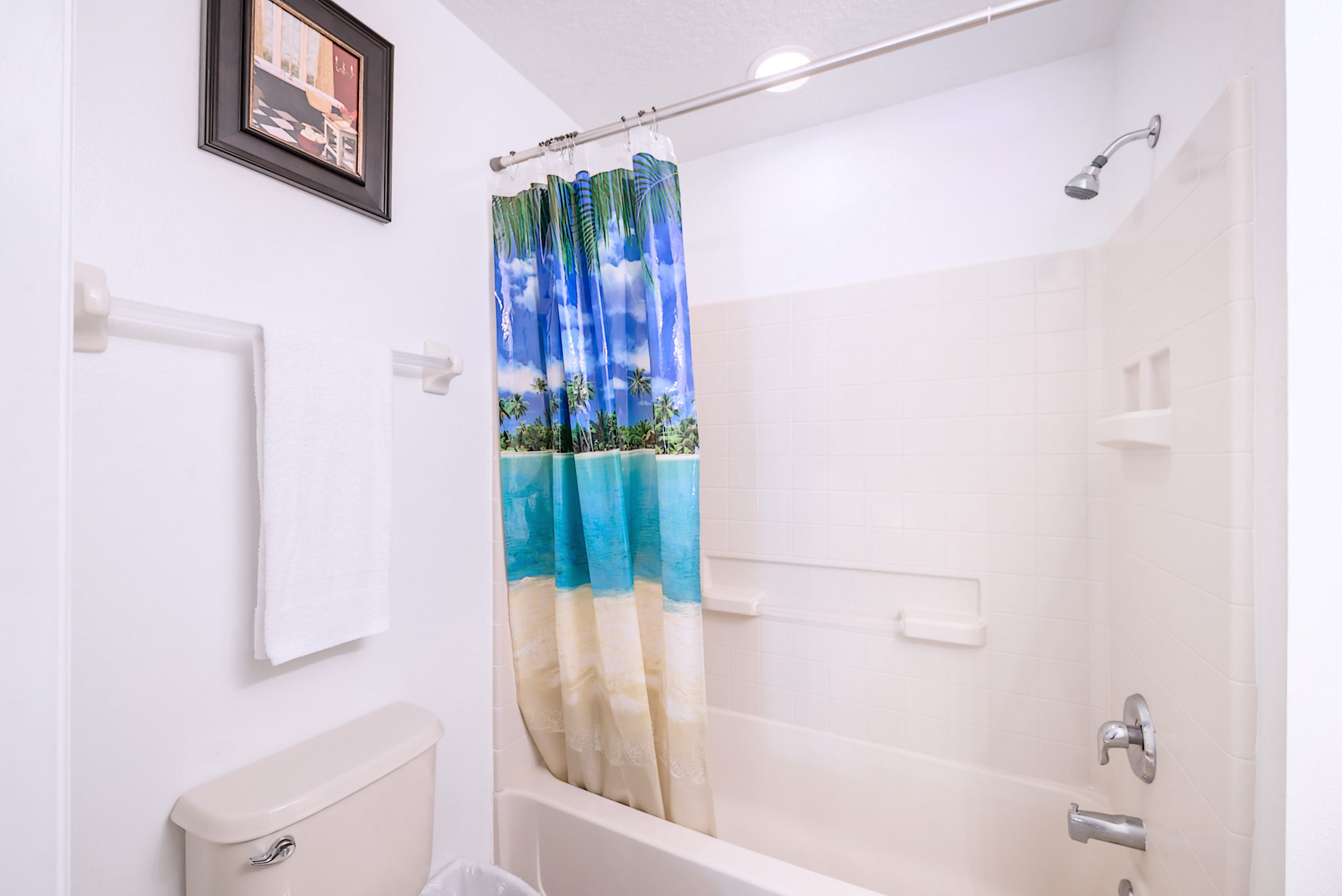 Bright Bathroom Featuring Dual Vanities And A Glass-Enclosed Walk-In Shower