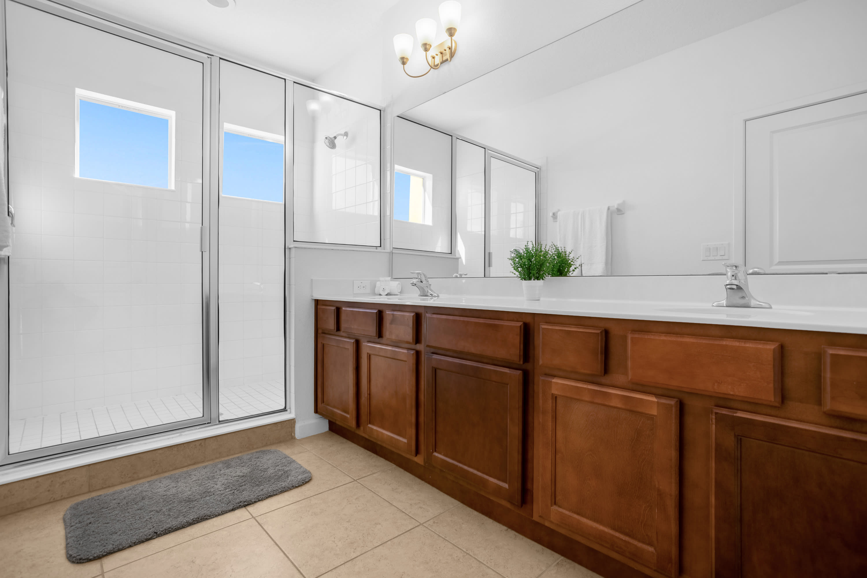 Sleek Bathroom With Ample Counter Space And Shower Area