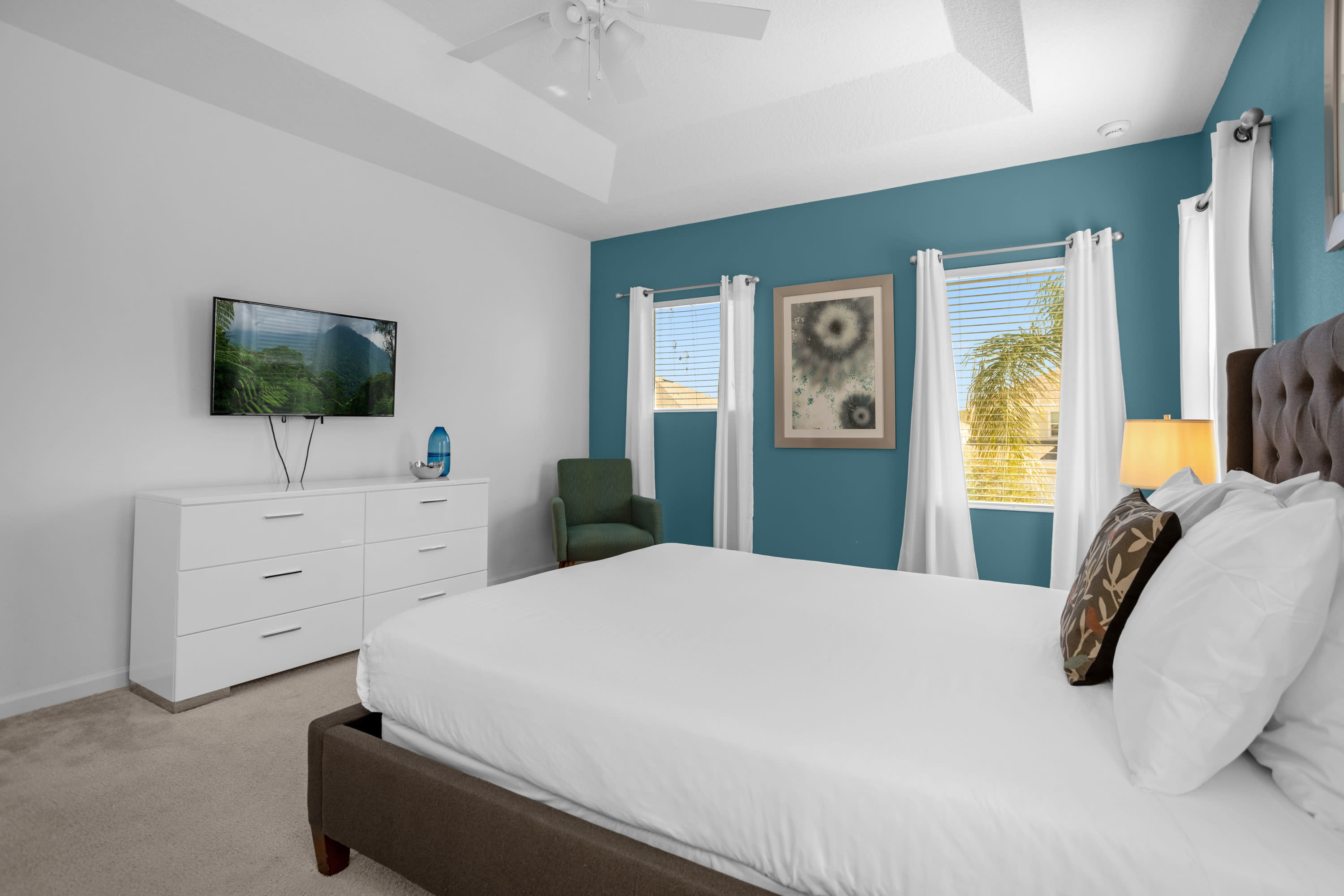 Spacious Bedroom With A Queen Bed And Elegant Blue Walls