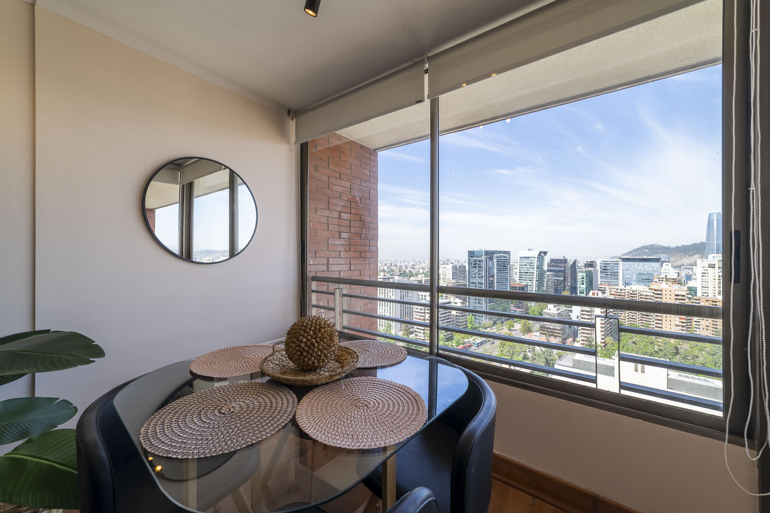 Enjoy stunning city views from this chic dining area, perfect for a cozy meal or morning coffee.