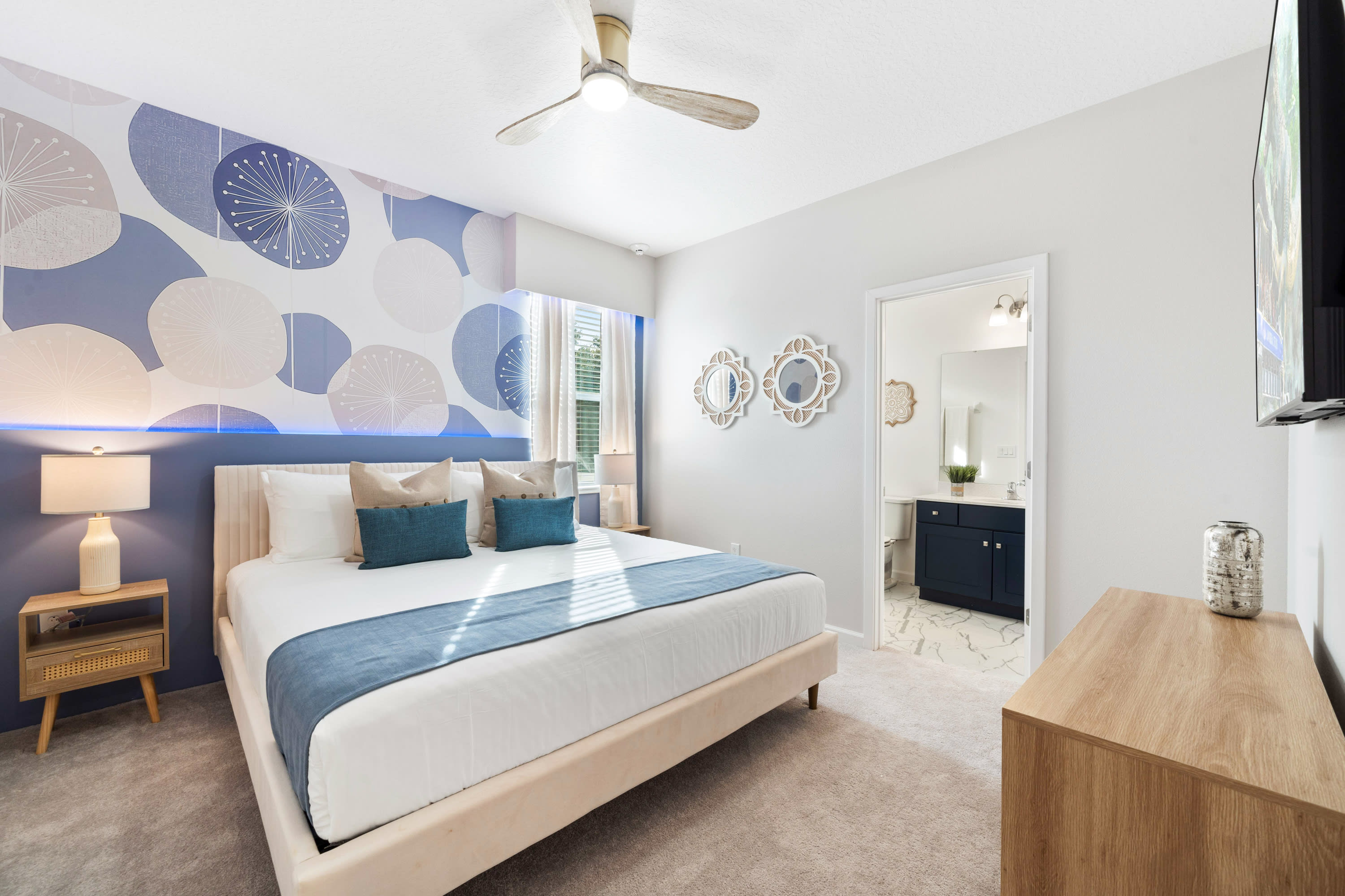 Spacious Bedroom Featuring A Luxurious King-Sized Bed And Unique Wall Art