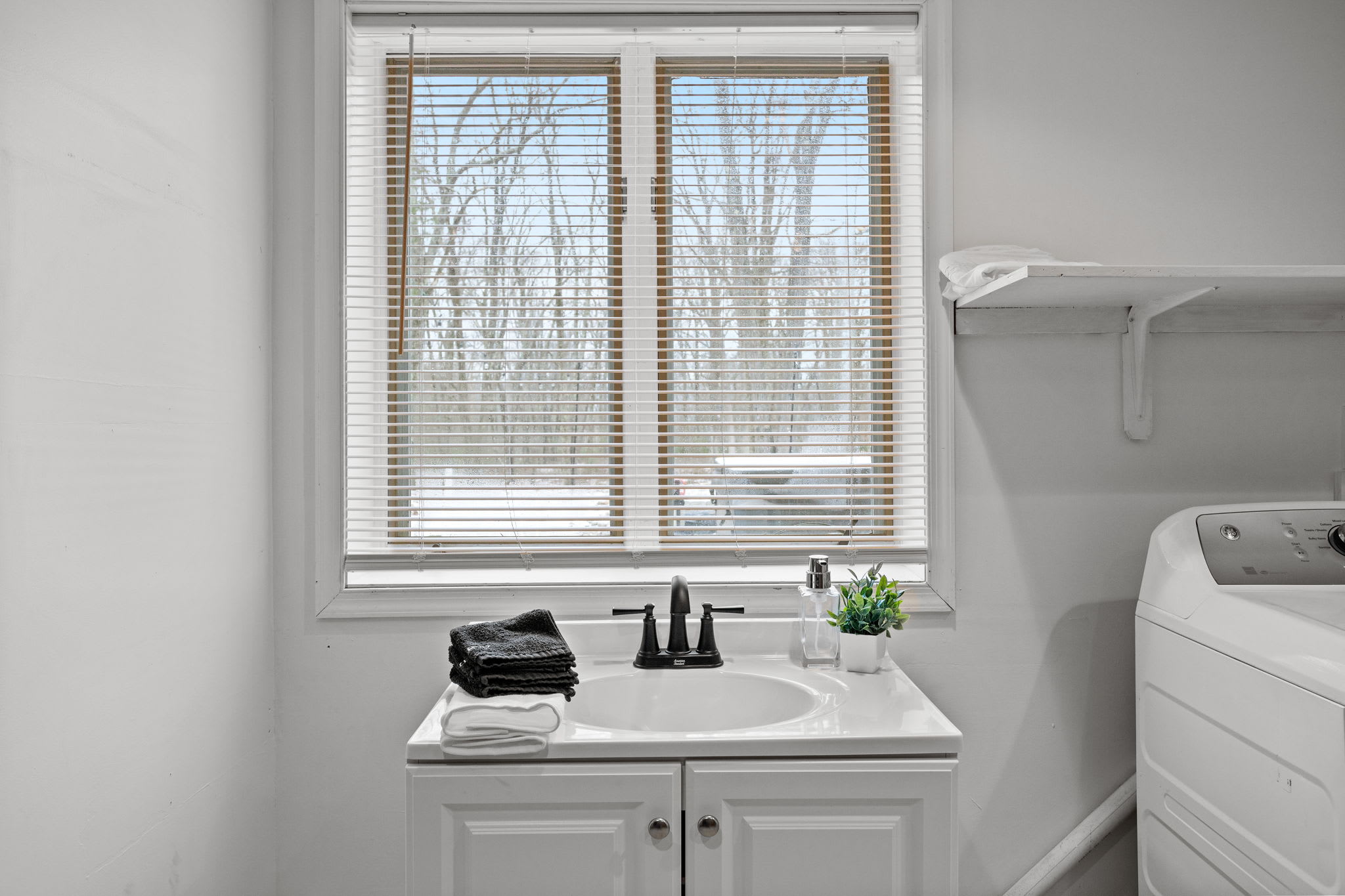 A well-lit laundry area with a scenic window view, making chores a little more enjoyable.