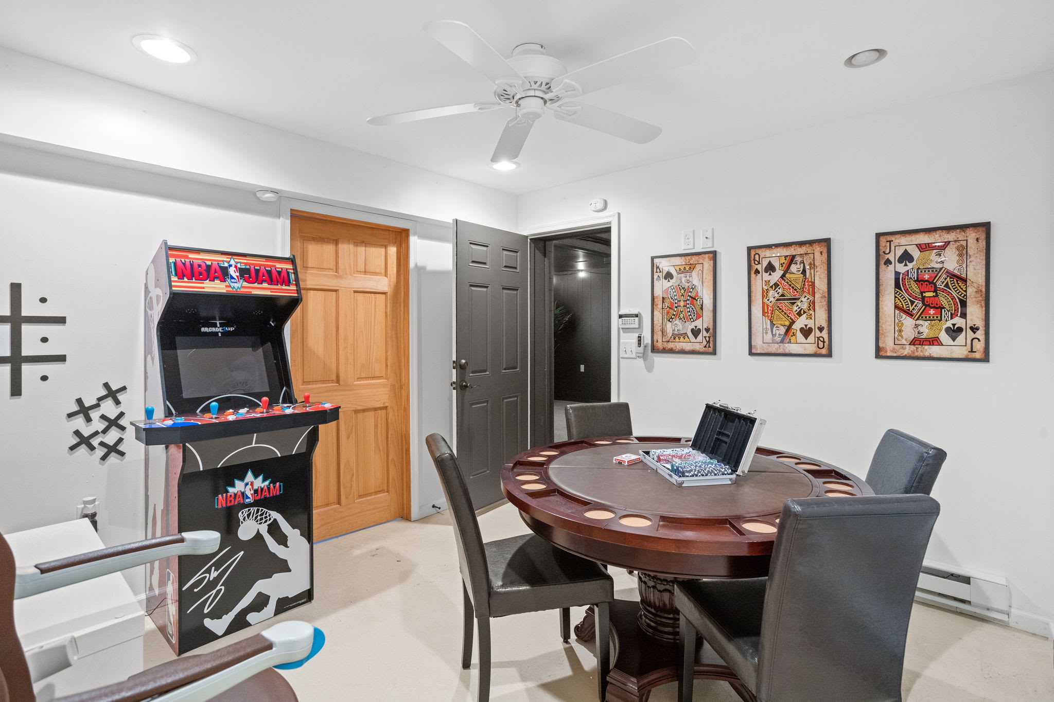 Classic arcade machines, a poker table, and game-inspired décor make this a nostalgic yet modern space for all ages.